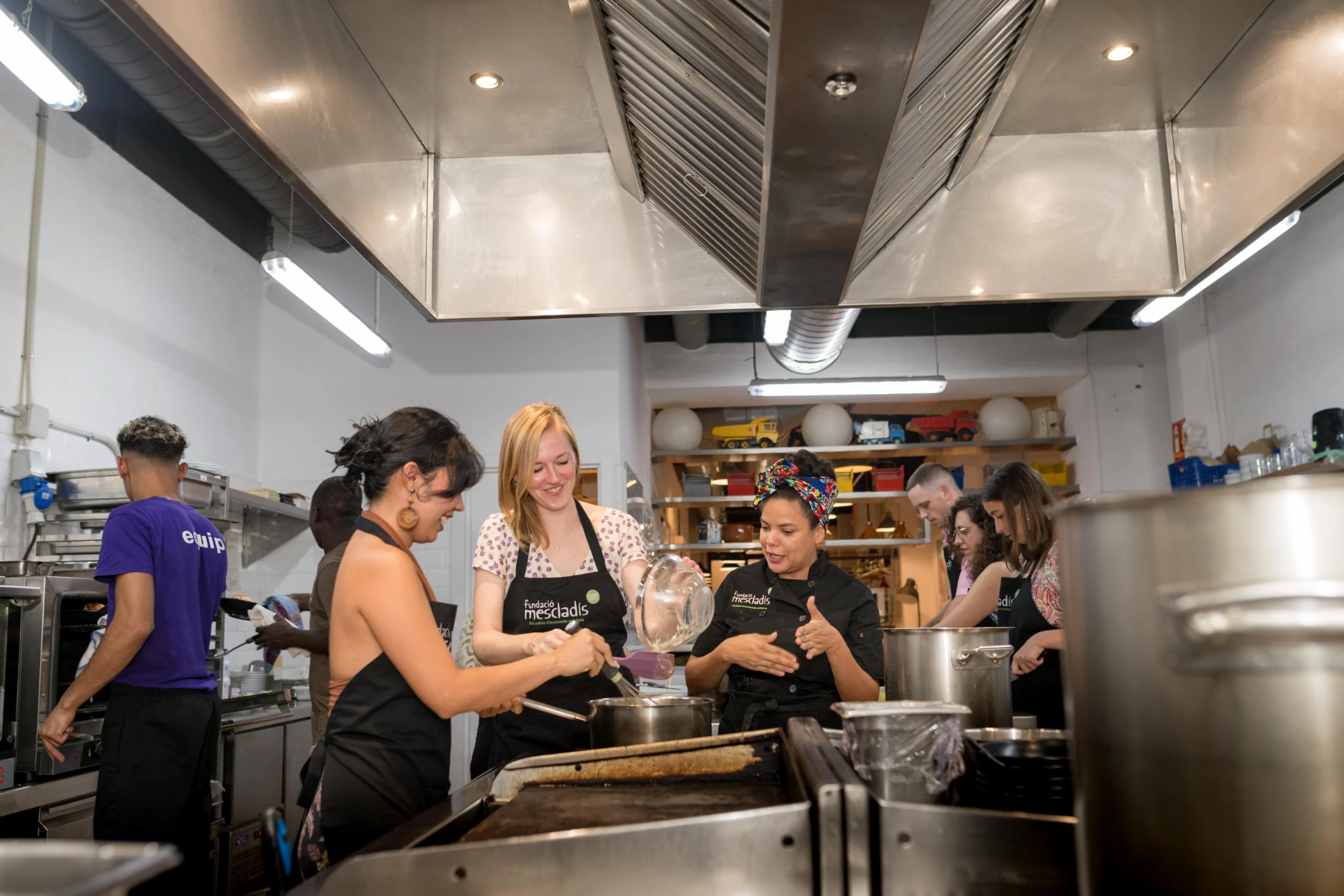 Action shot of chef and guests cooking
