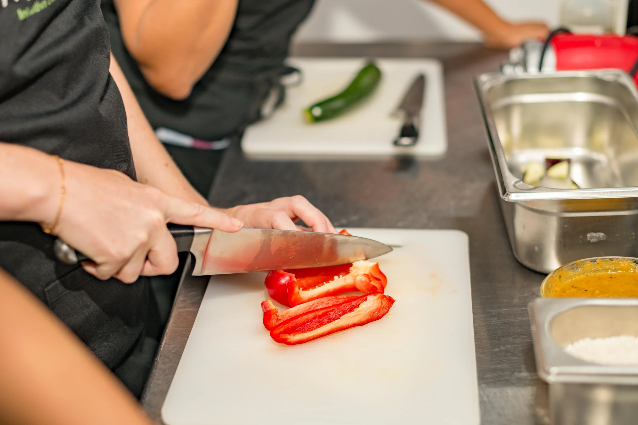 Chopping vegetables during Barcelona Cooking Class for Social Good