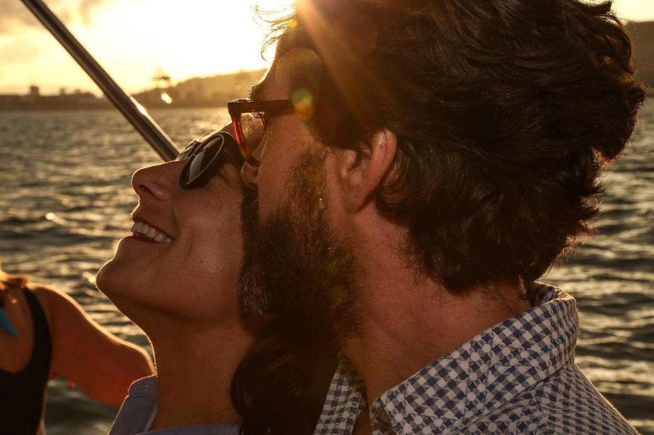 Close up of happy couple on yacht during Barcelona sunset sailing experience
