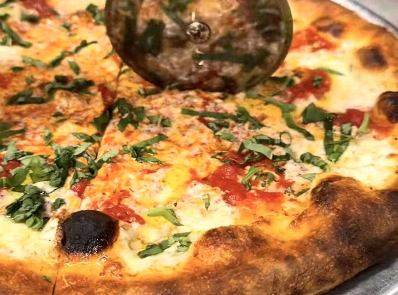 Close up of pizza being sliced