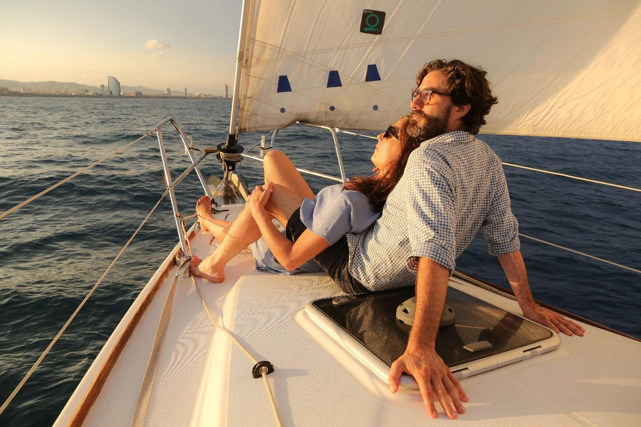 Couple relaxing on luxury yacht during Barcelona sunset sailing experience