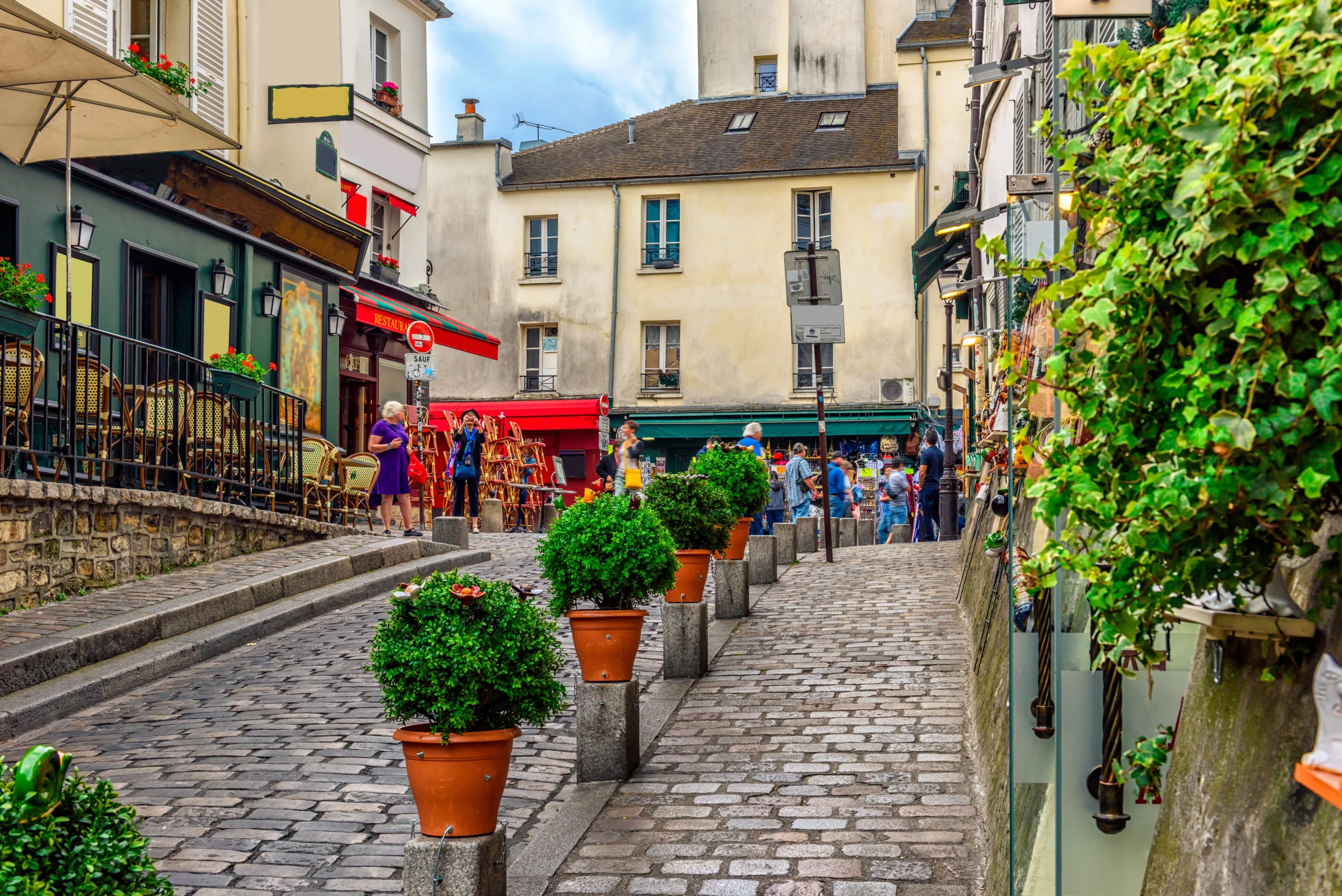 Cozy street with tables of cafe in quarter Montmartre in Paris