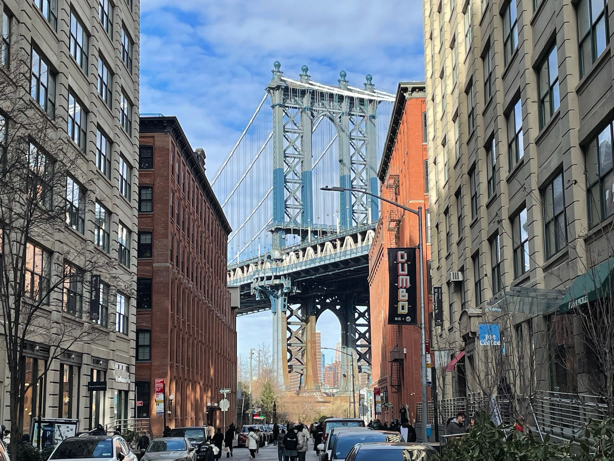 Brooklyn bridge seen between buildings on DUMBO tour