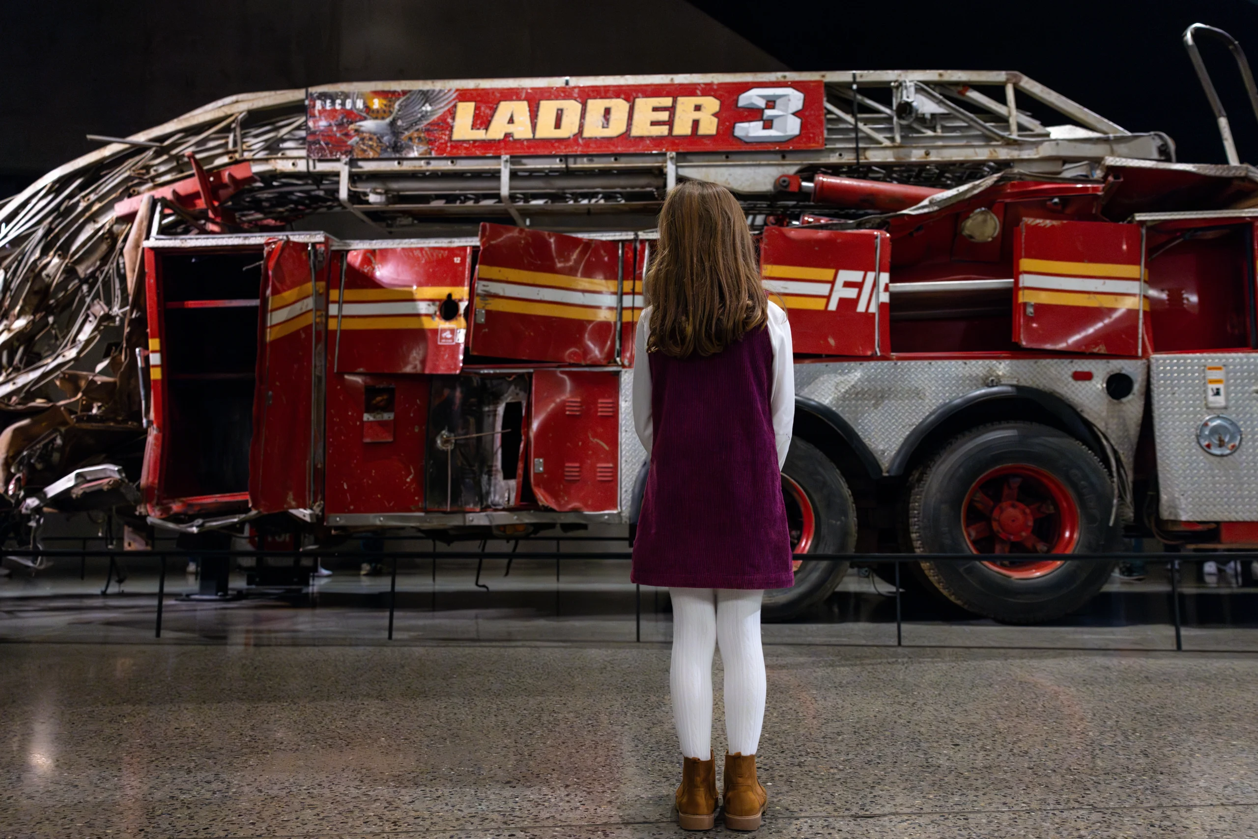 Girl looking at Ladder 3 exhibit during 9/11 Memorial Walking Tour with VIP Tour of Museum