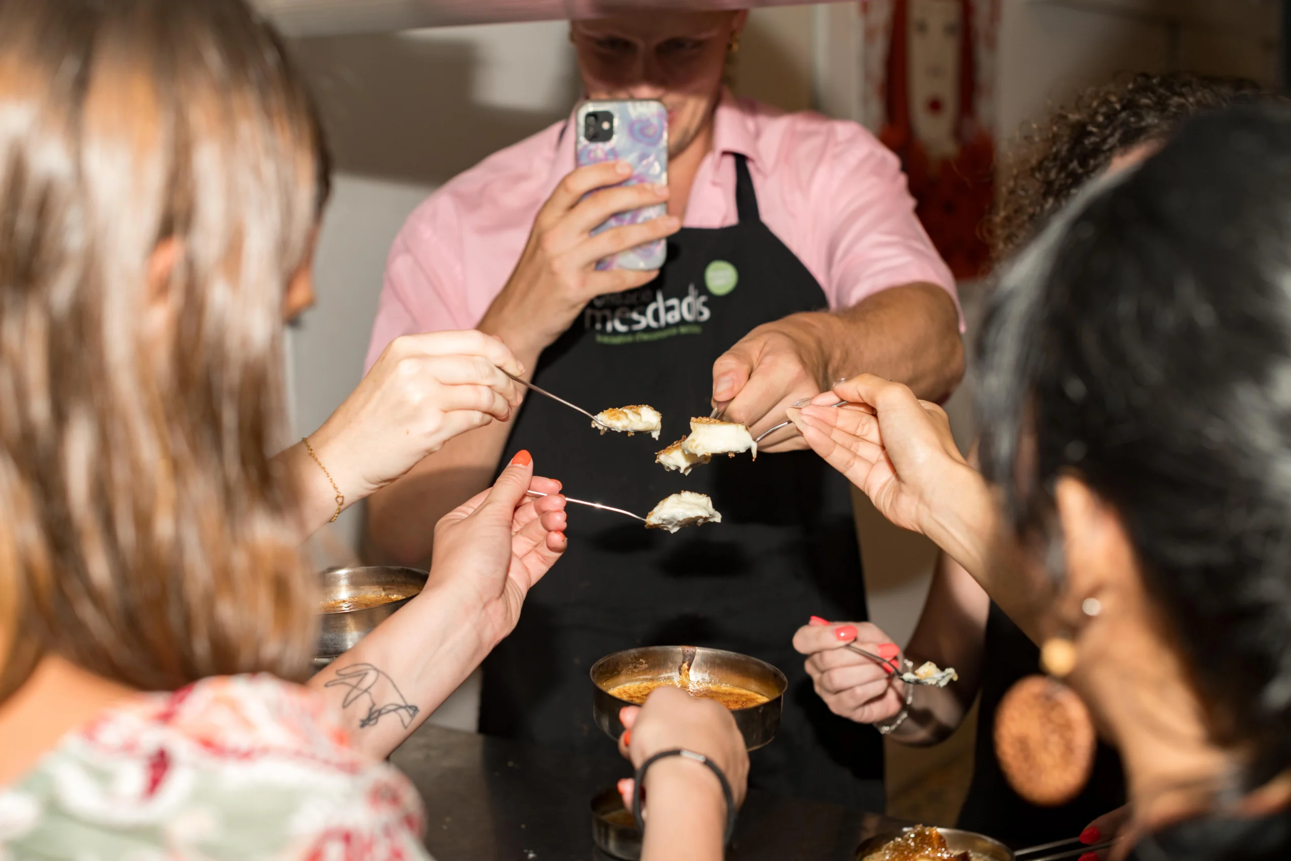 Guests enjoying cooking dessert during Barcelona Cooking Class for Social Good