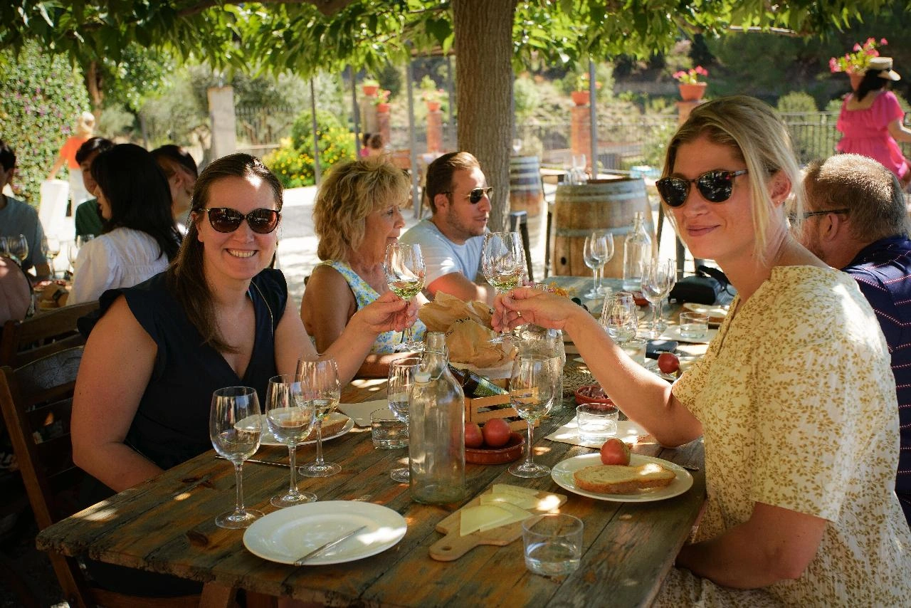 Guests having wine and posing during wine tasting, e-bike and sailing experience in Alella