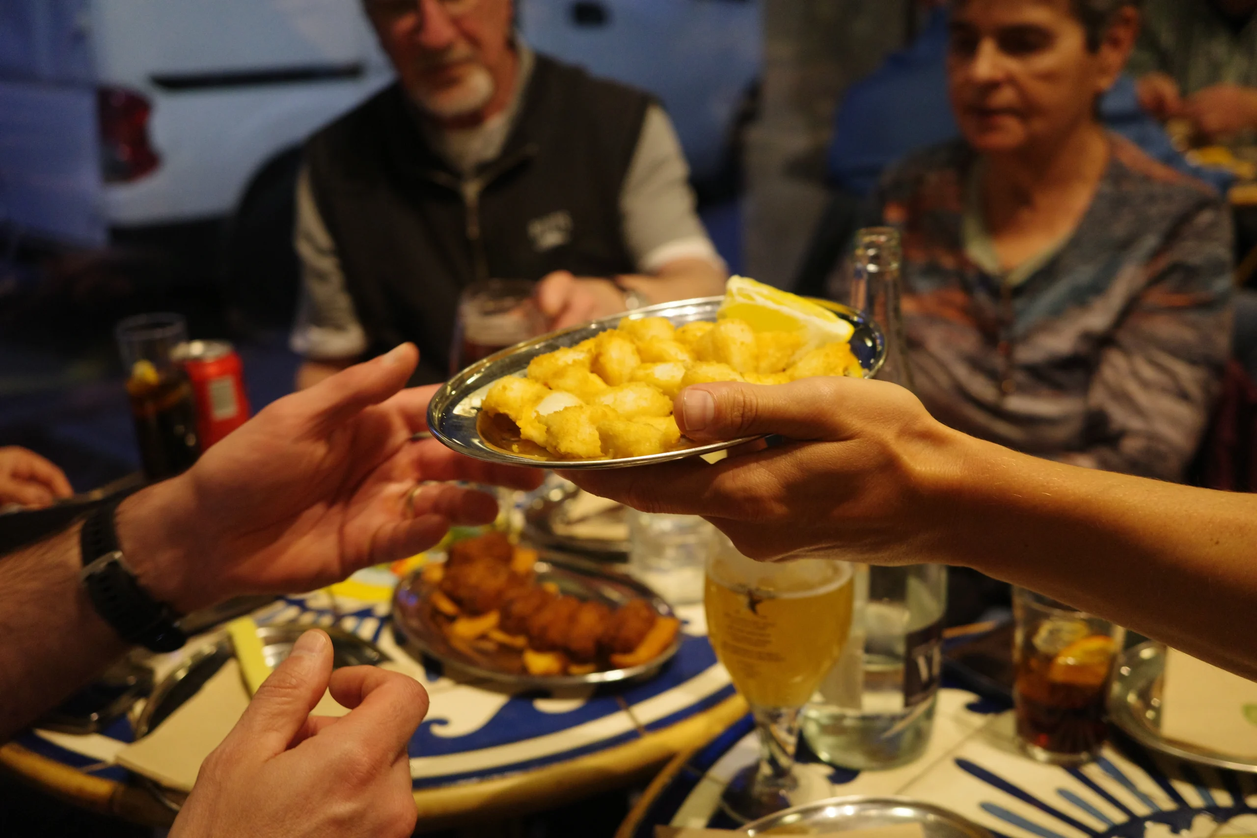Handing tapas to guests during Barceloneta Tapas Experience