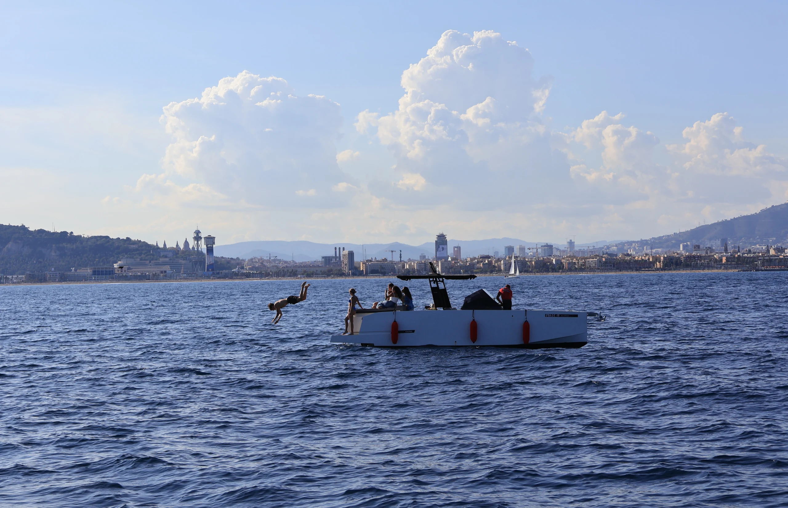 High-end motorboat in the distance during Sitges Sailing Tour