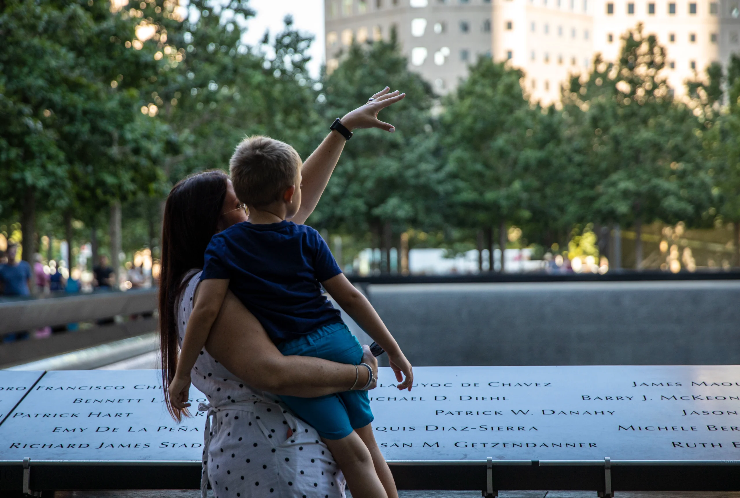 Mother holding child at 9/11 Ground Zero memorial