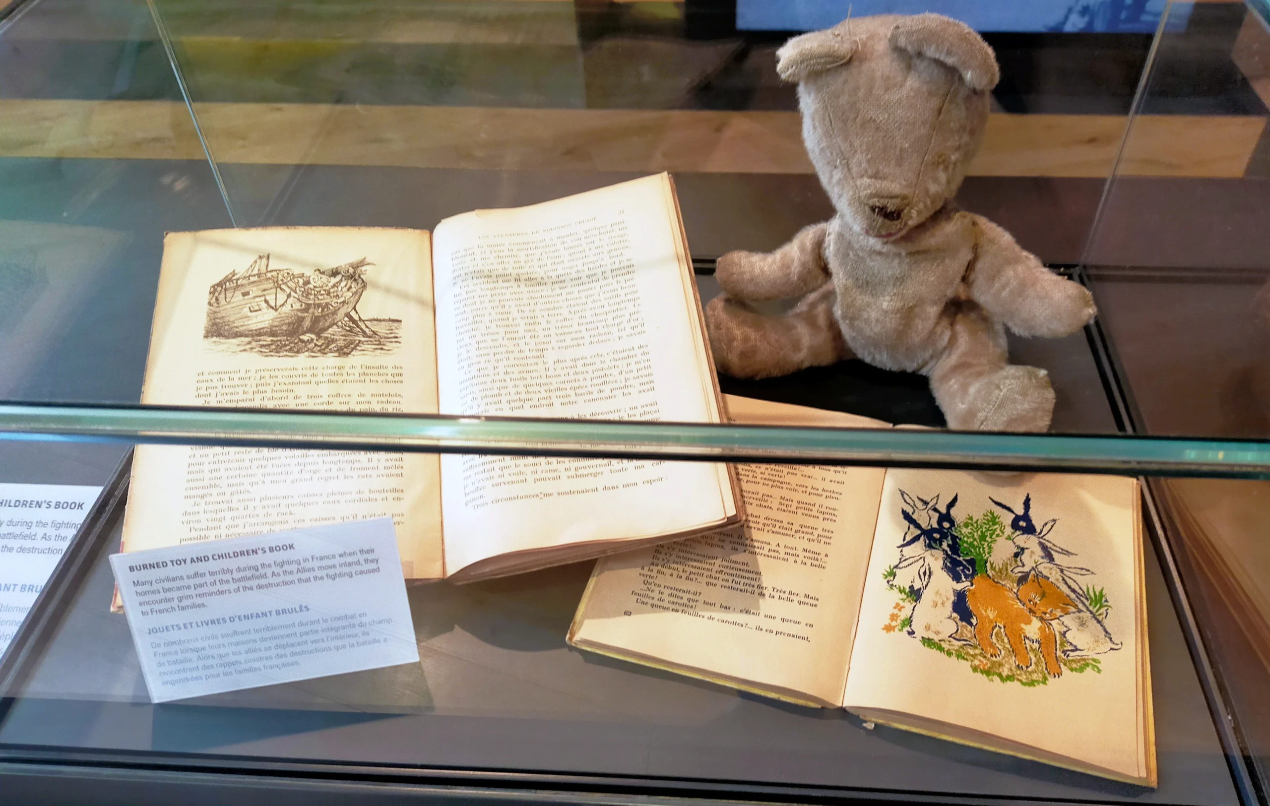 Normandy museum exhibit of children's book and teddy bear