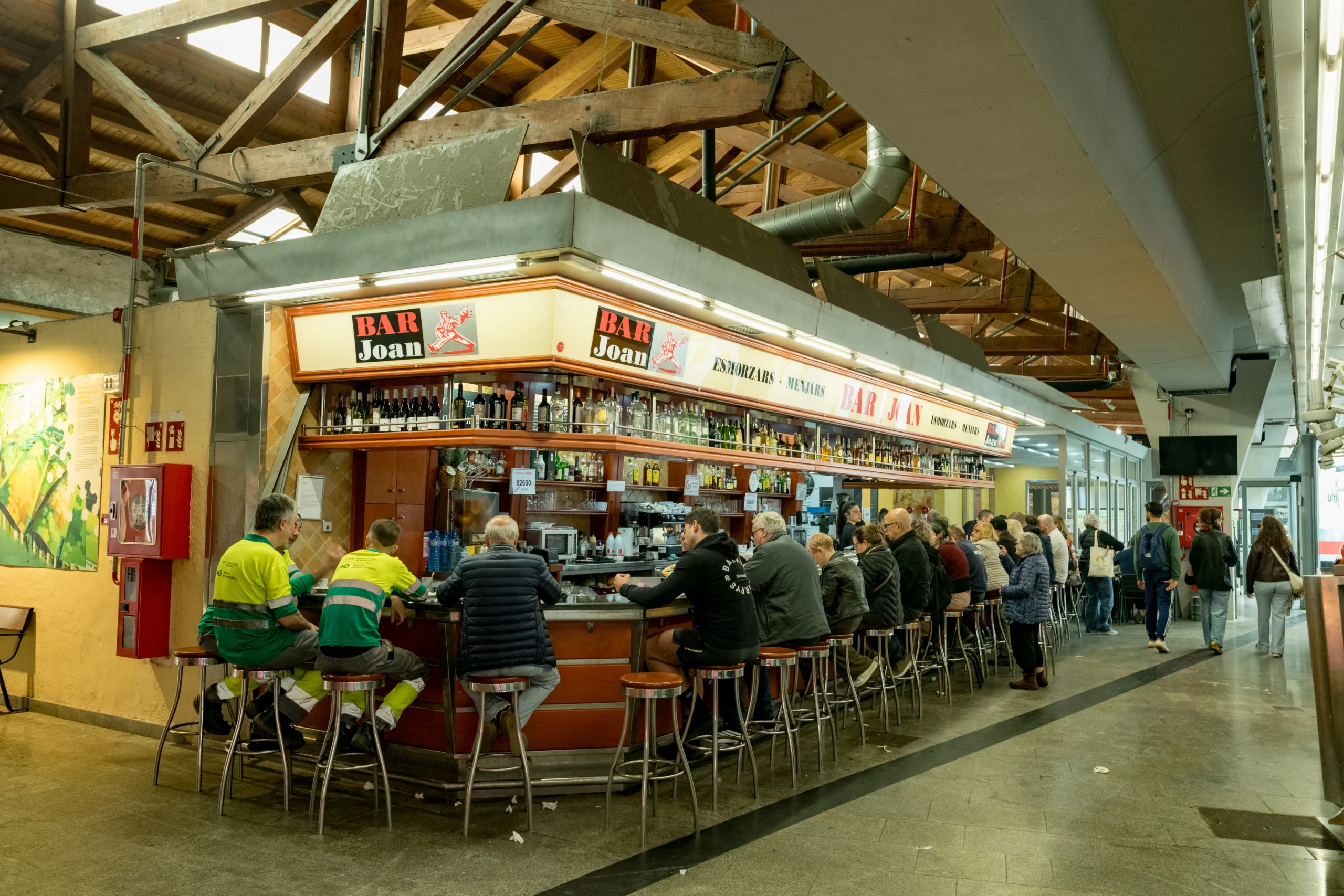 People eating at Bar Joan market stall during Barcelona Markets Tour