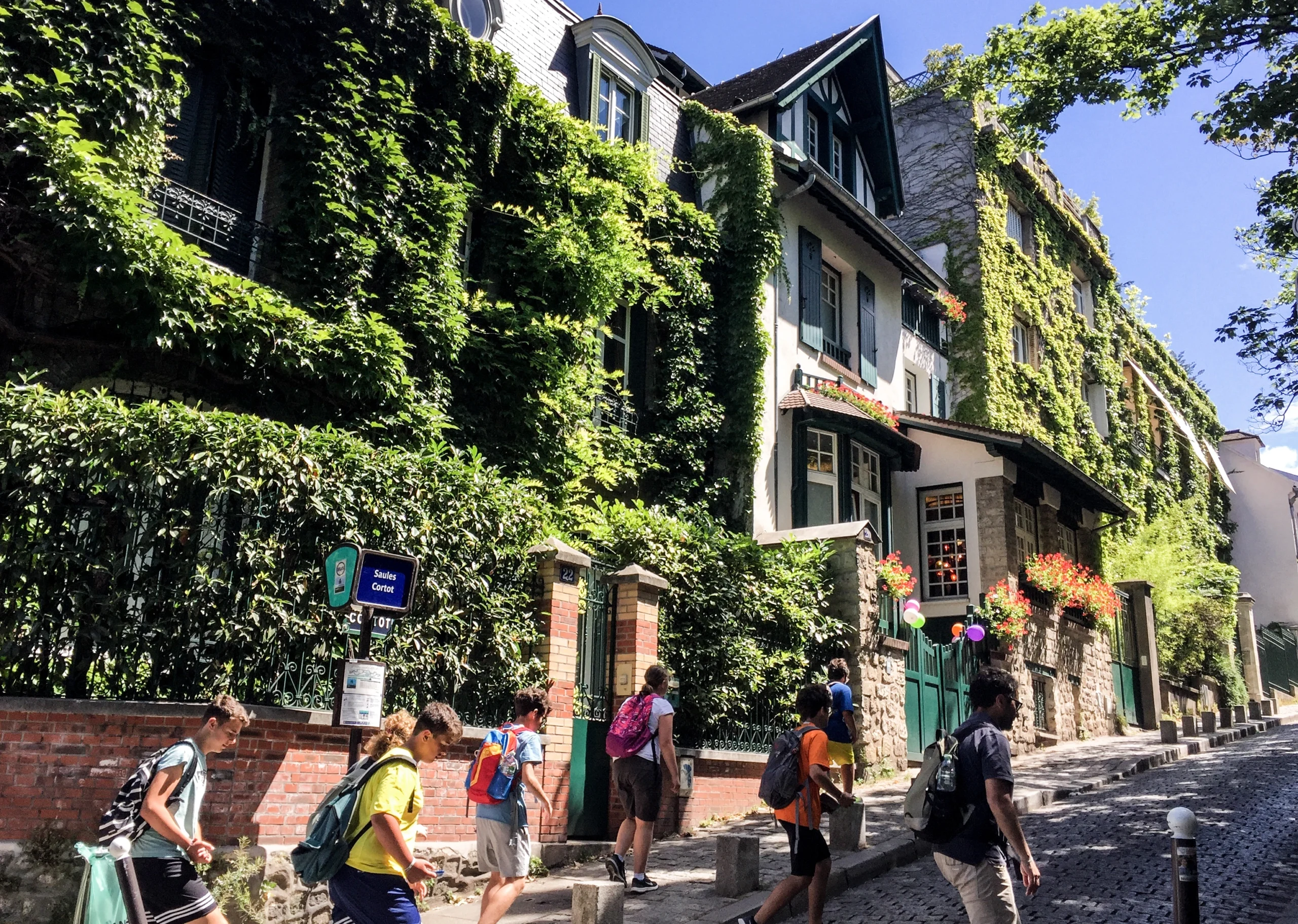 People walking through streets of Montmartre on a sunny day during private guided tour