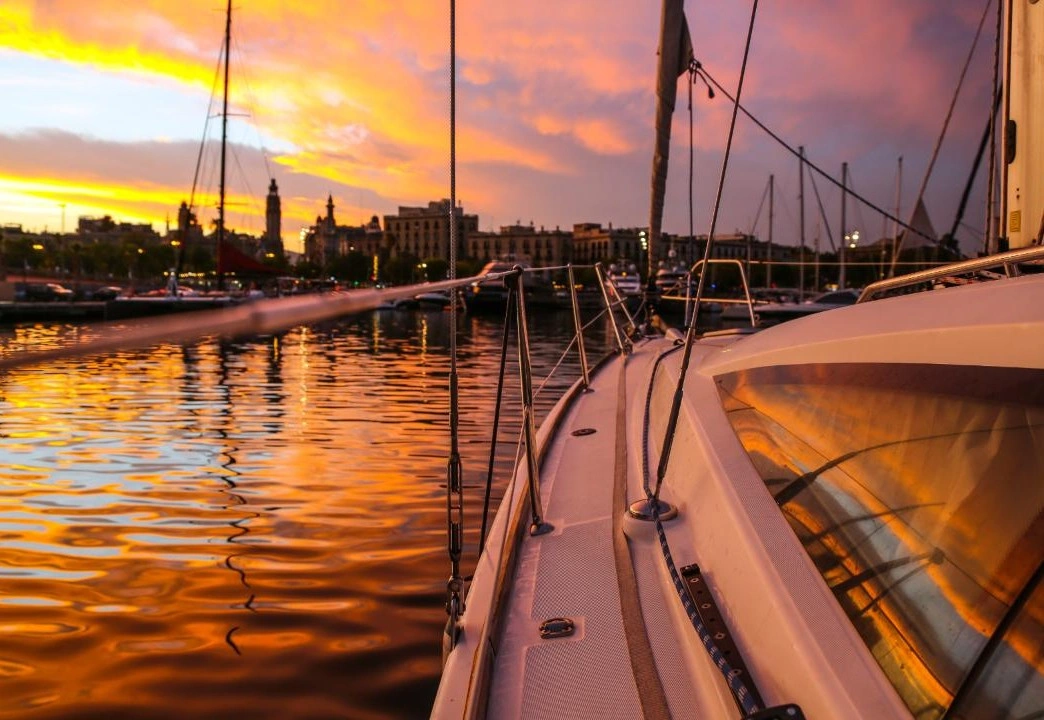 Side of yacht and waters during sunset