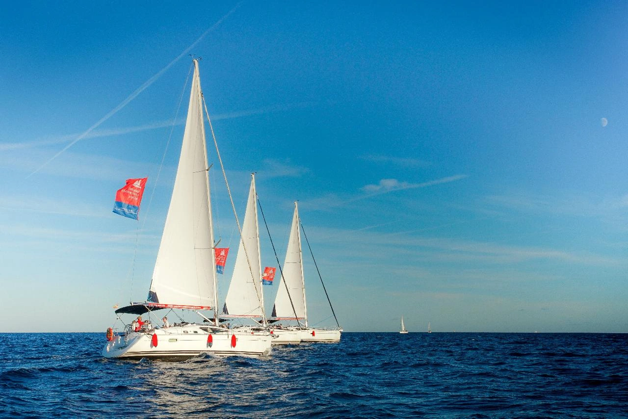 Three yachts in the water during wine tasting, e-bike and sailing experience in Alella