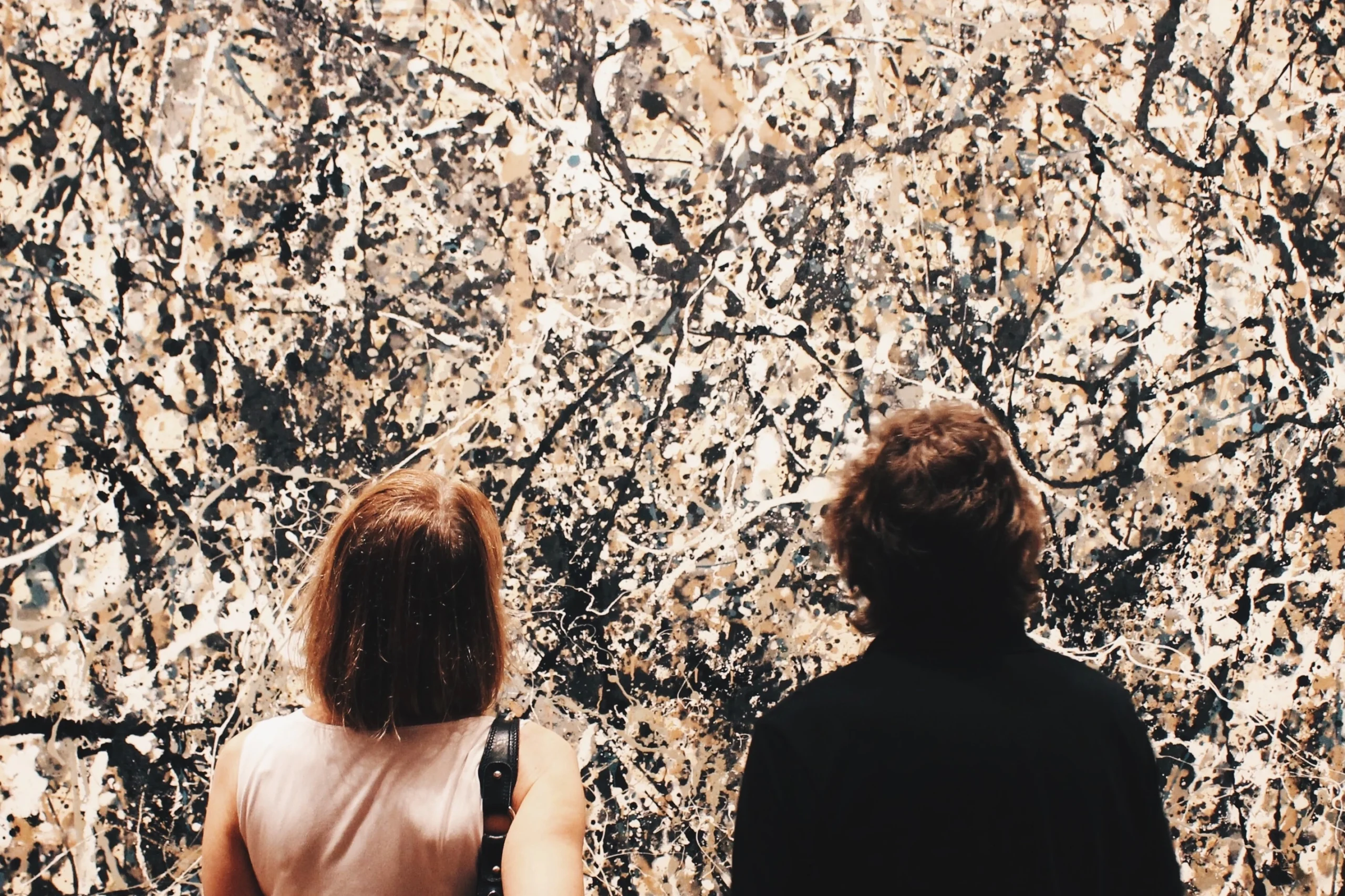 Two people looking at Pollock artwork in The Met in NYC