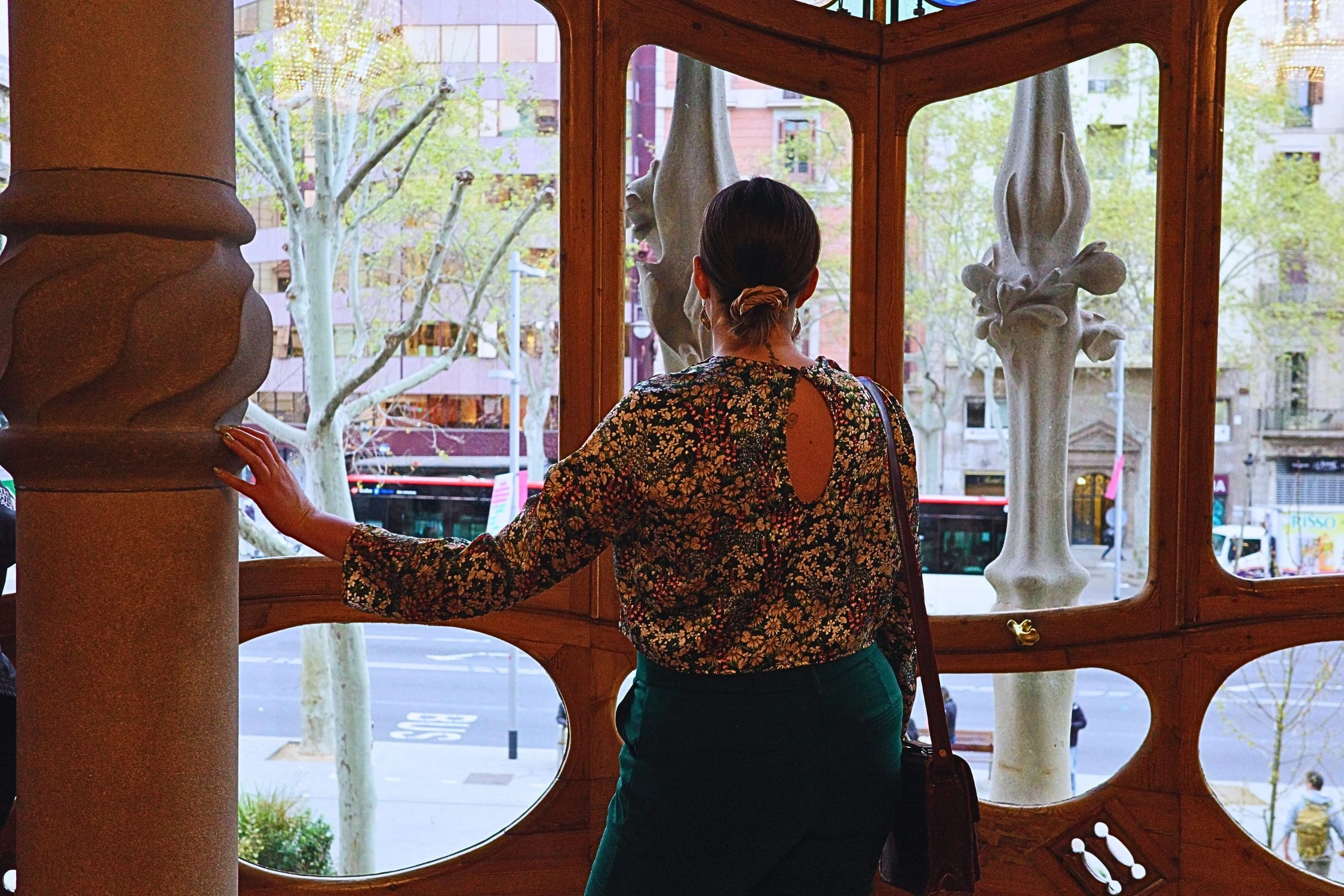 Woman looking outside of window in Casa Batllo in Barcelona