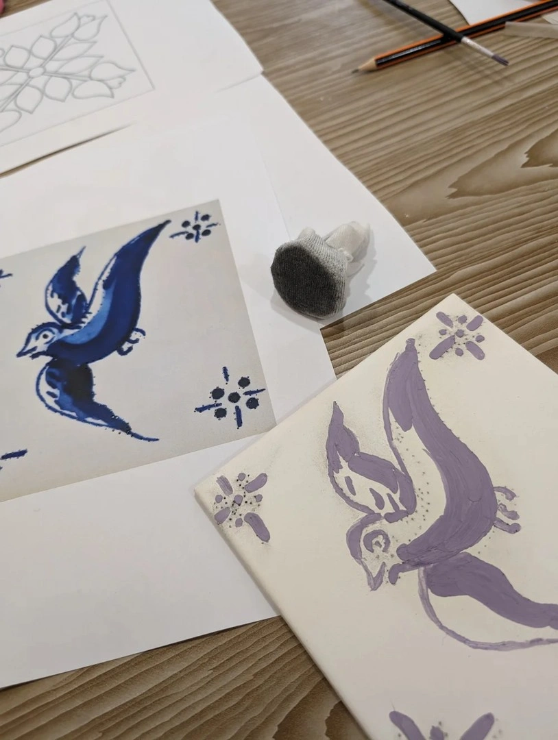 Artwork and tile in progress side by side during Traditional Tile-Painting Workshop in Lisbon