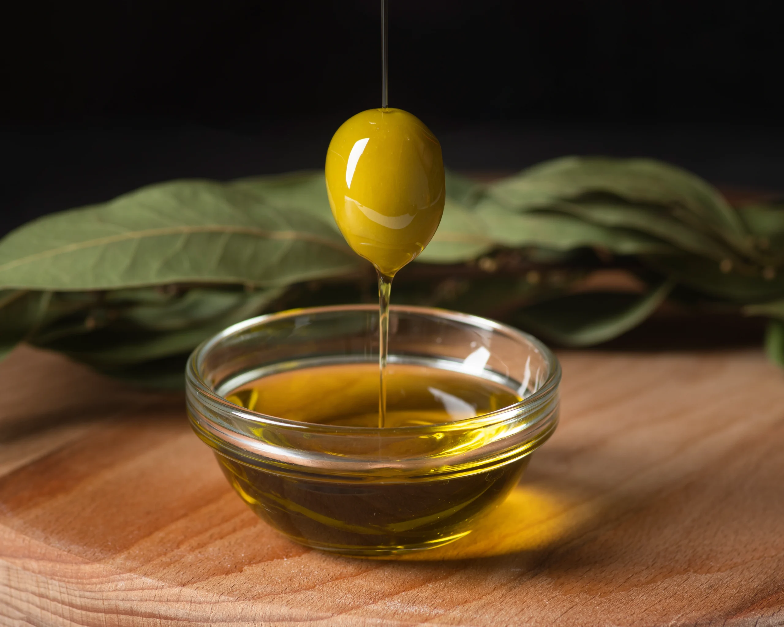 Close up of olive oil and green olive