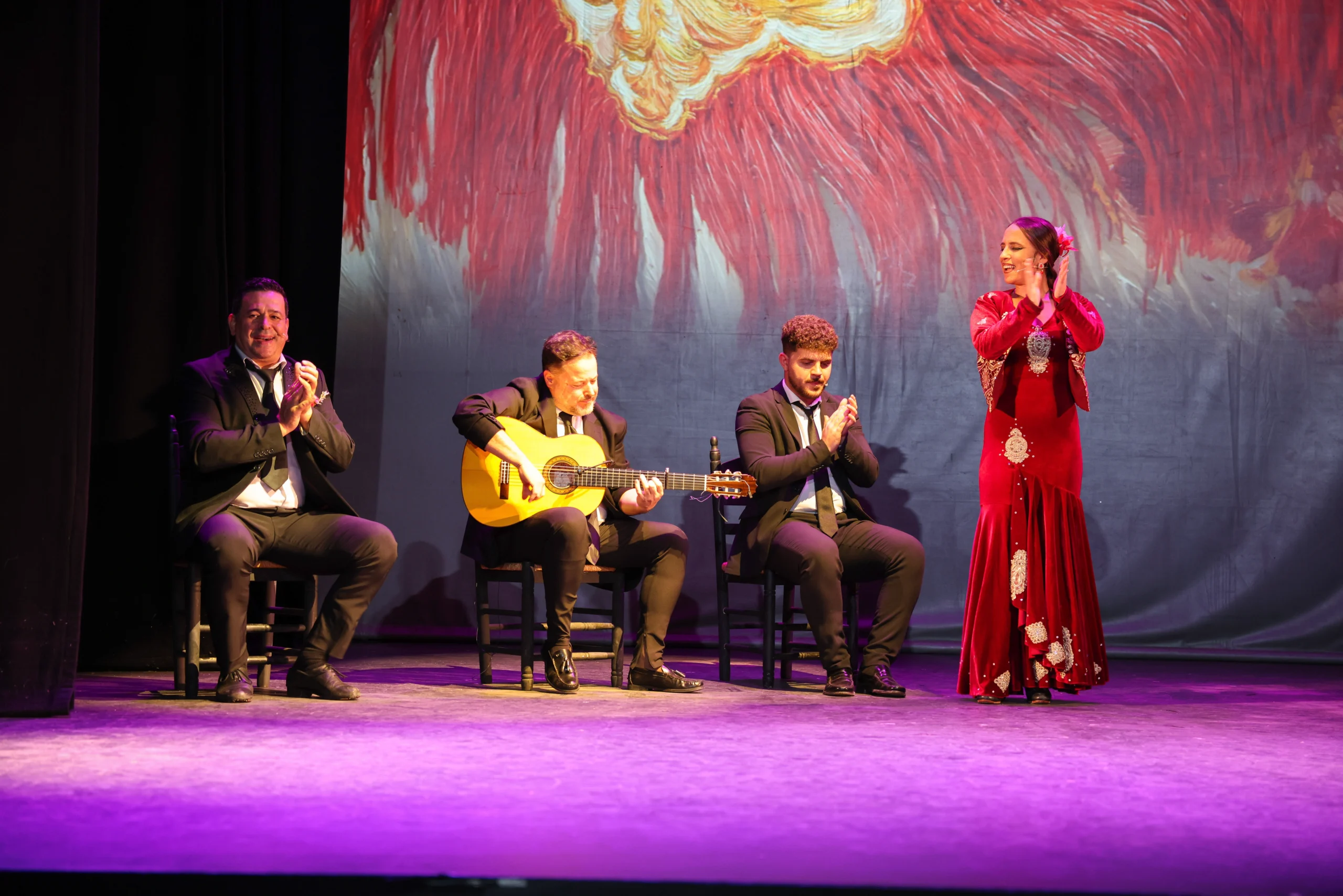 Flamenco dancer next to musicians during live show in Seville