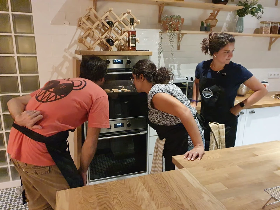 Guests checking the oven during Pastel de Nata Baking Experience in Lisbon