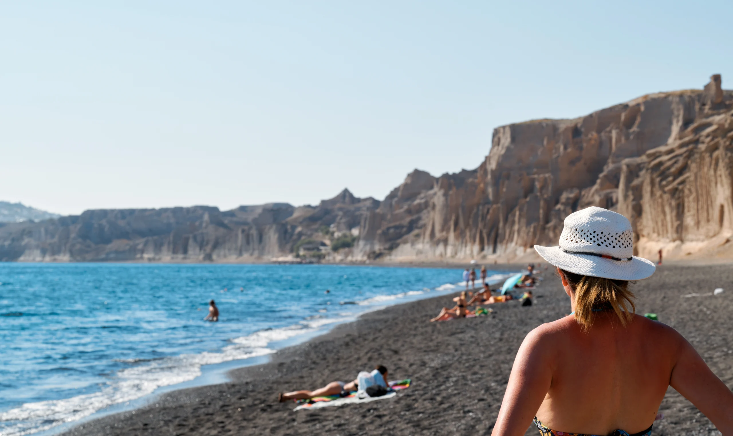 Tourist on Vlichada Beach in Santorini Greece