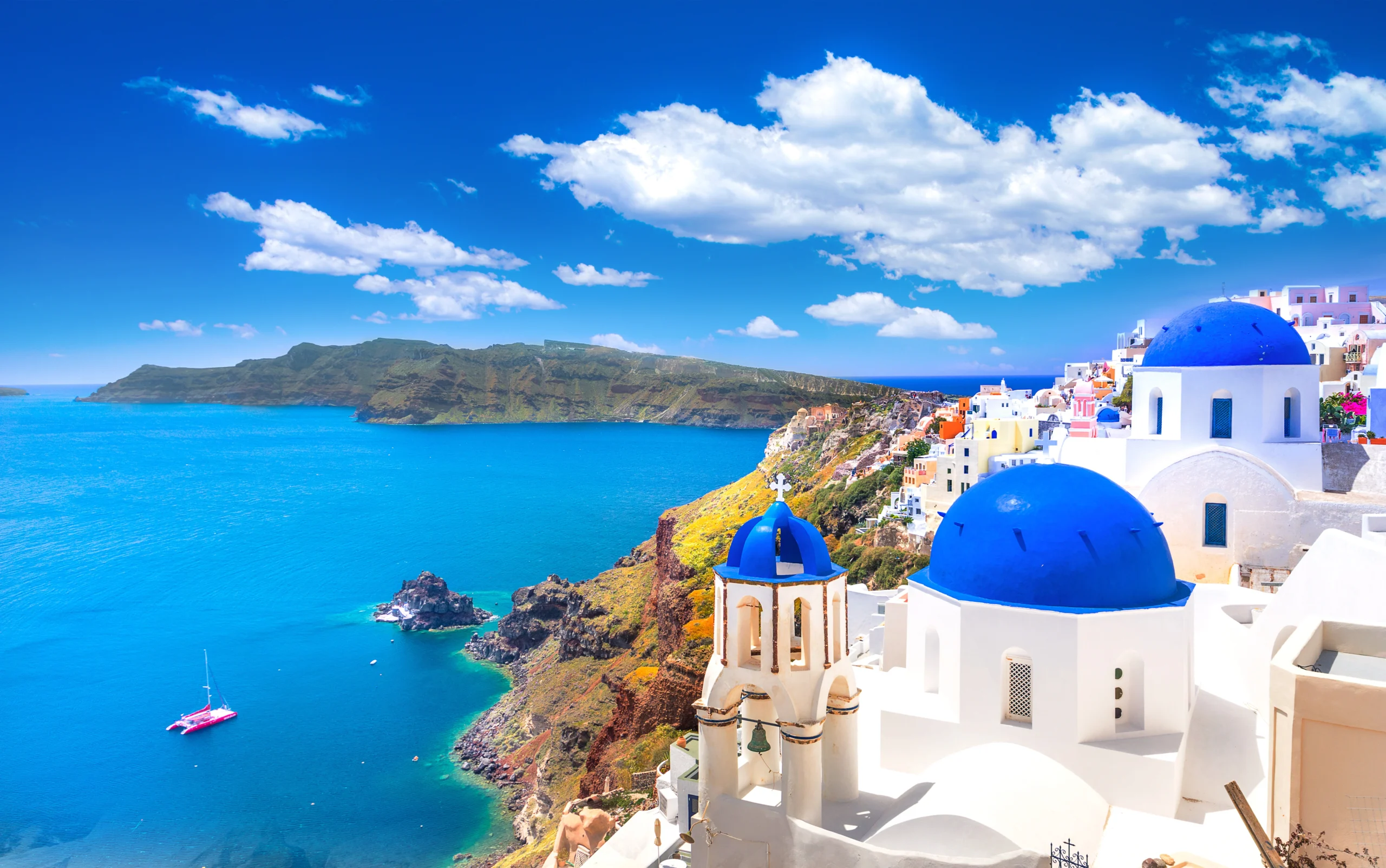 Traditional and famous houses and churches with blue domes over the Caldera, Aegean sea