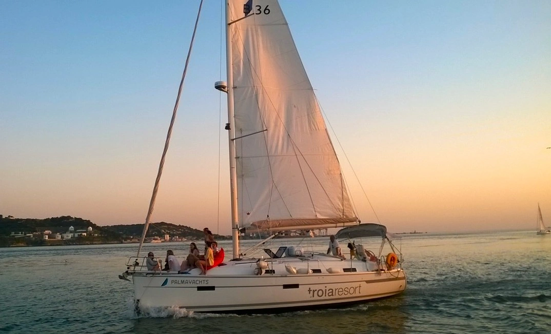 View of guests and private yacht in the waters during Sunset Sail in Lisbon