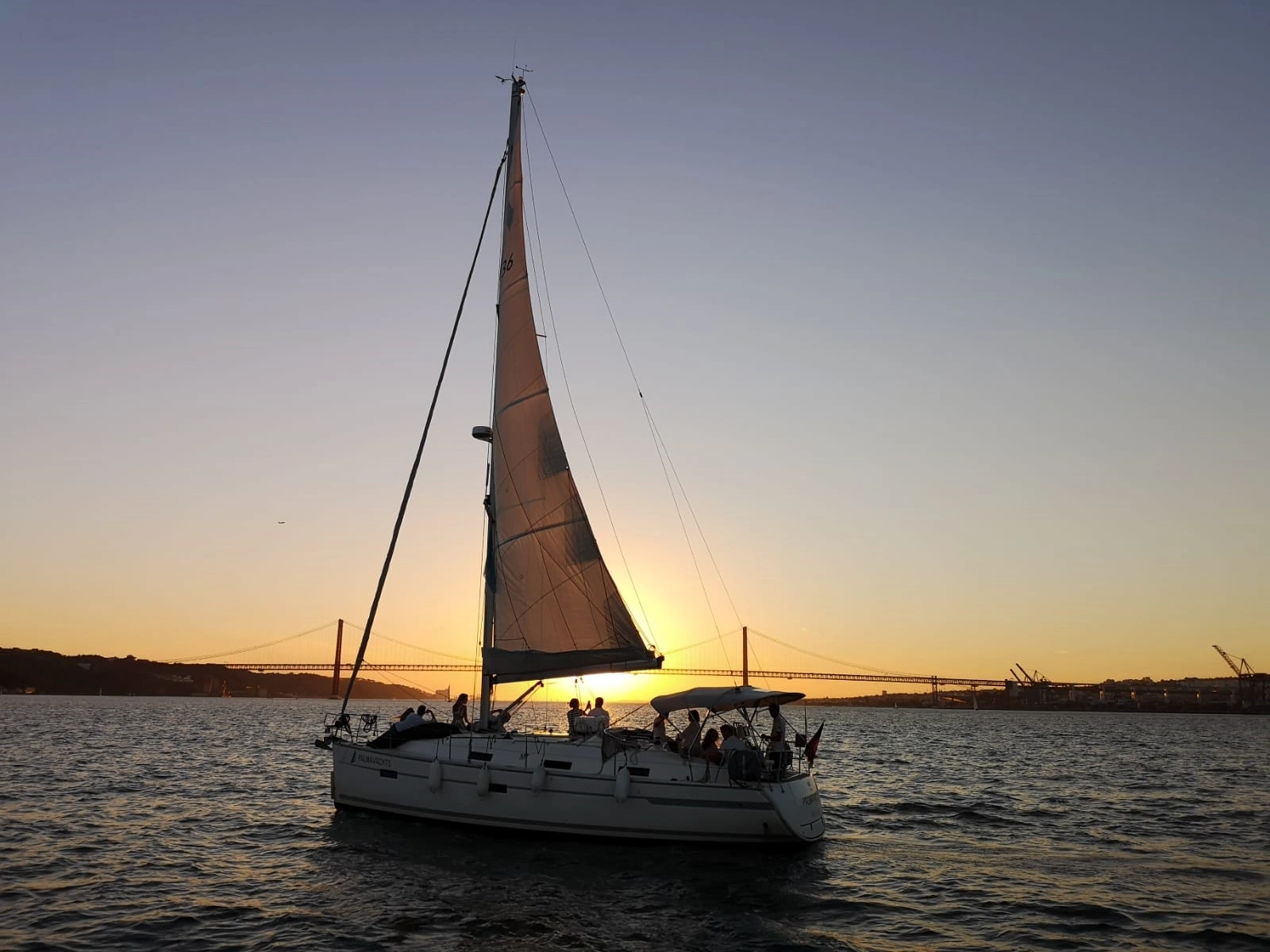View of private yacht in the ocean during Sunset Sail in Lisbon