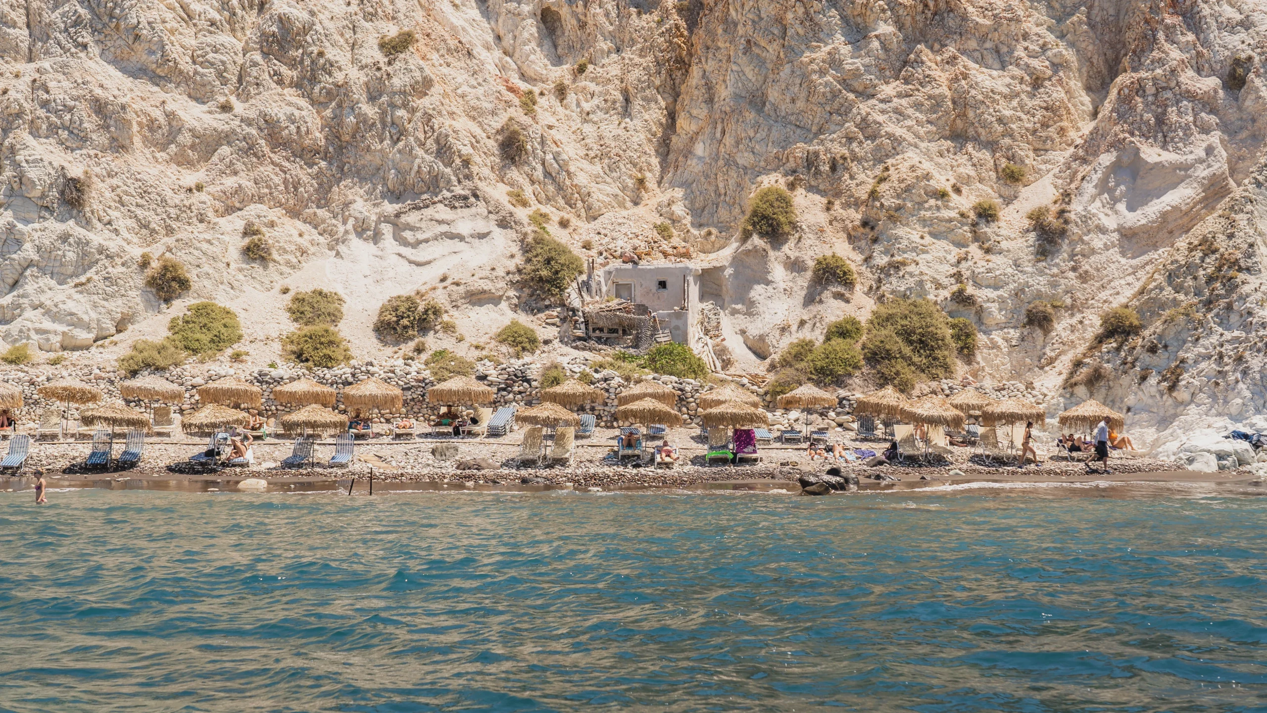 View of the shore of White Beach in Santorini during premium Caldera Sunset Sail experience
