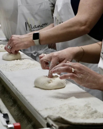 Closeup of group shaping dough