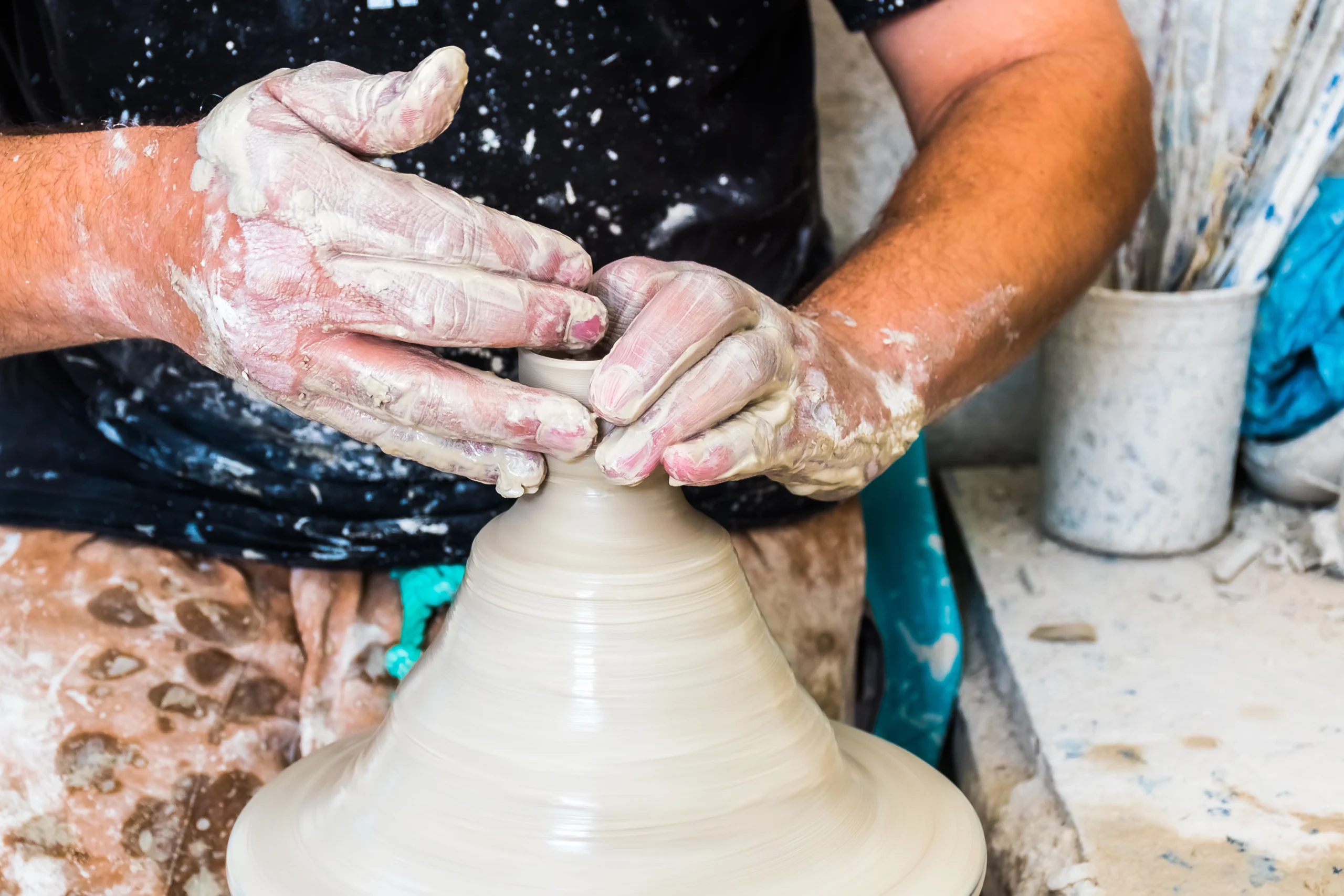 A moroccan pottery maker creates ceramics in a workshop in old medina during Artisan Workshops & Royal Fes Experience