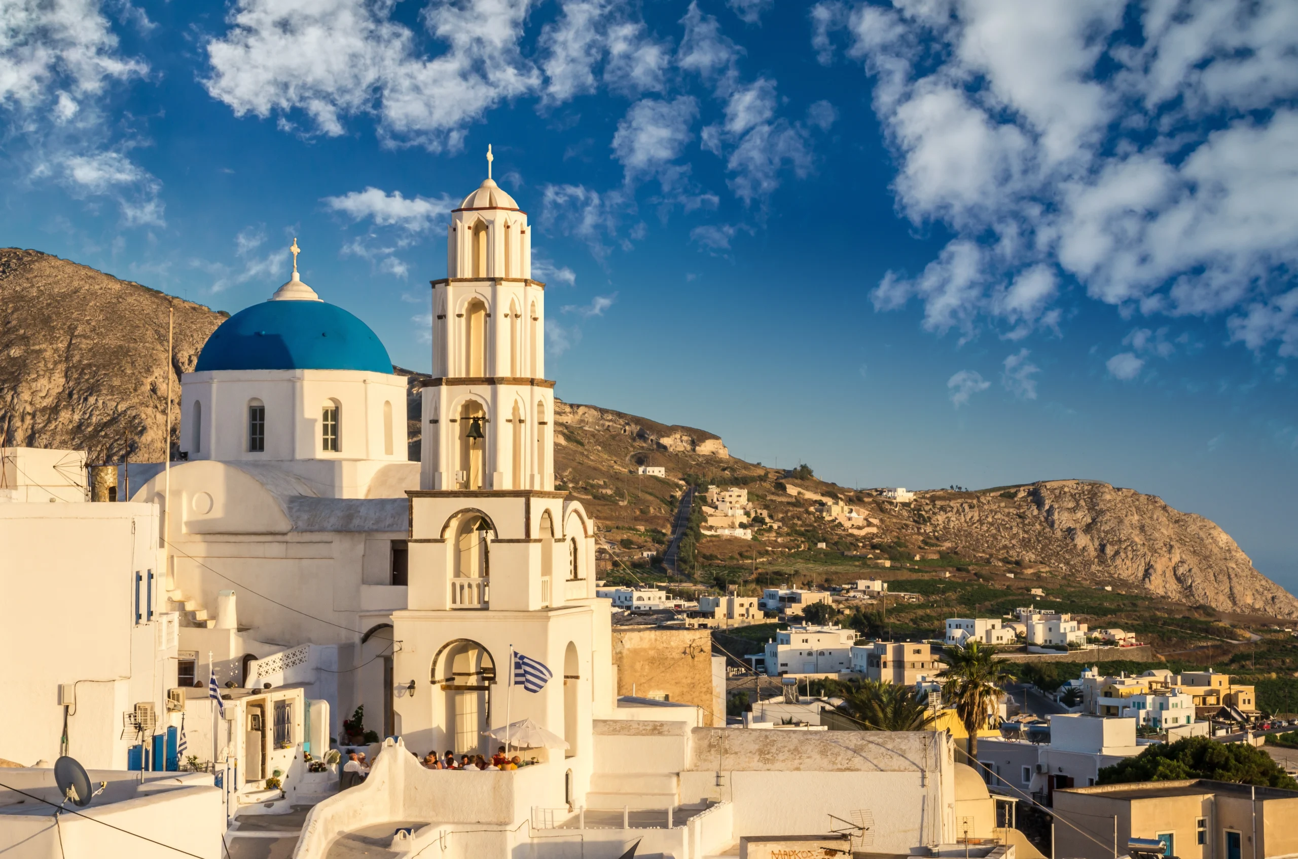 Blue domes of churches and white houses in Pyrgos Santorini