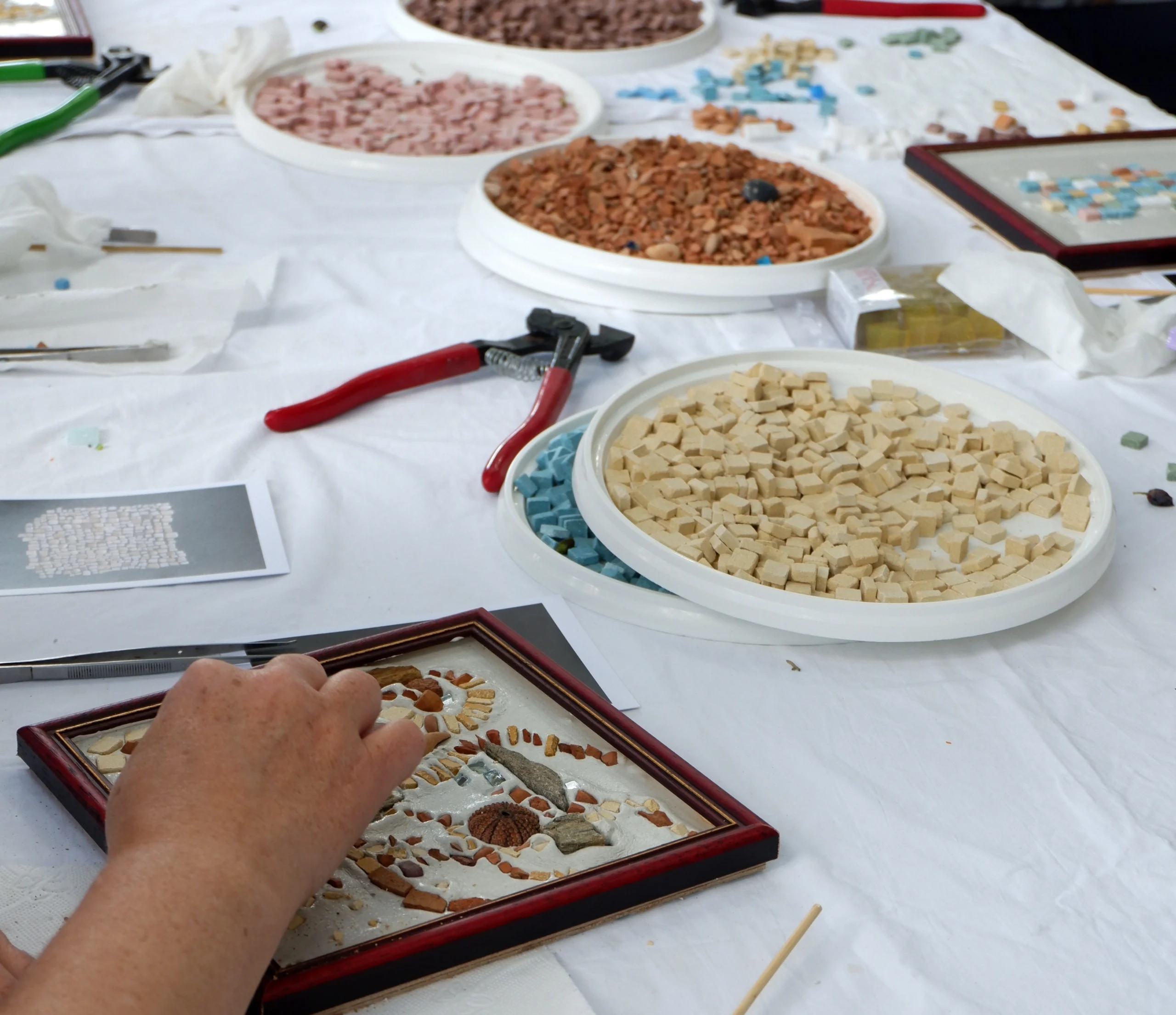 Guest making mosaic tile during Mosaic Workshop with Cycladic Artist in Mykonos