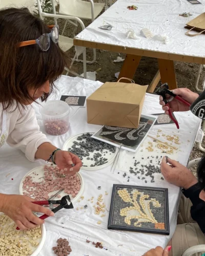 Guests making their mosaic tiles during Mosaic Workshop with Cycladic Artist in Mykonos