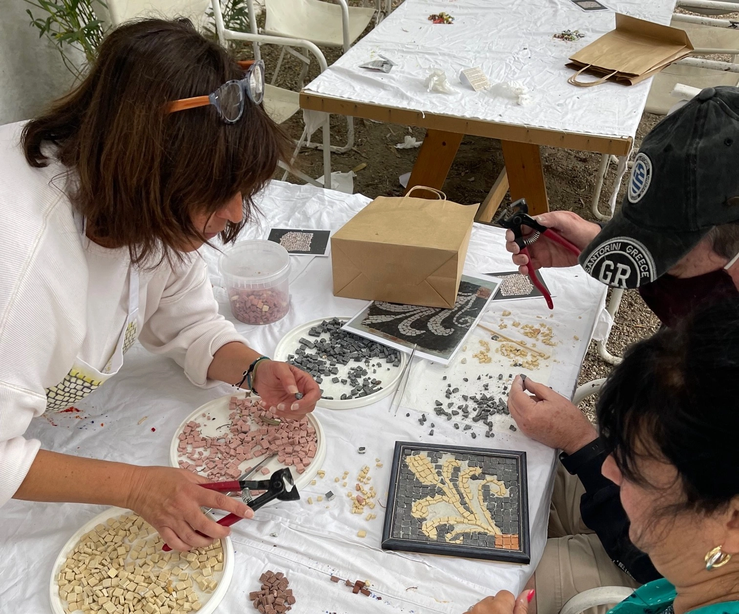 Guests making their mosaic tiles during Mosaic Workshop with Cycladic Artist in Mykonos