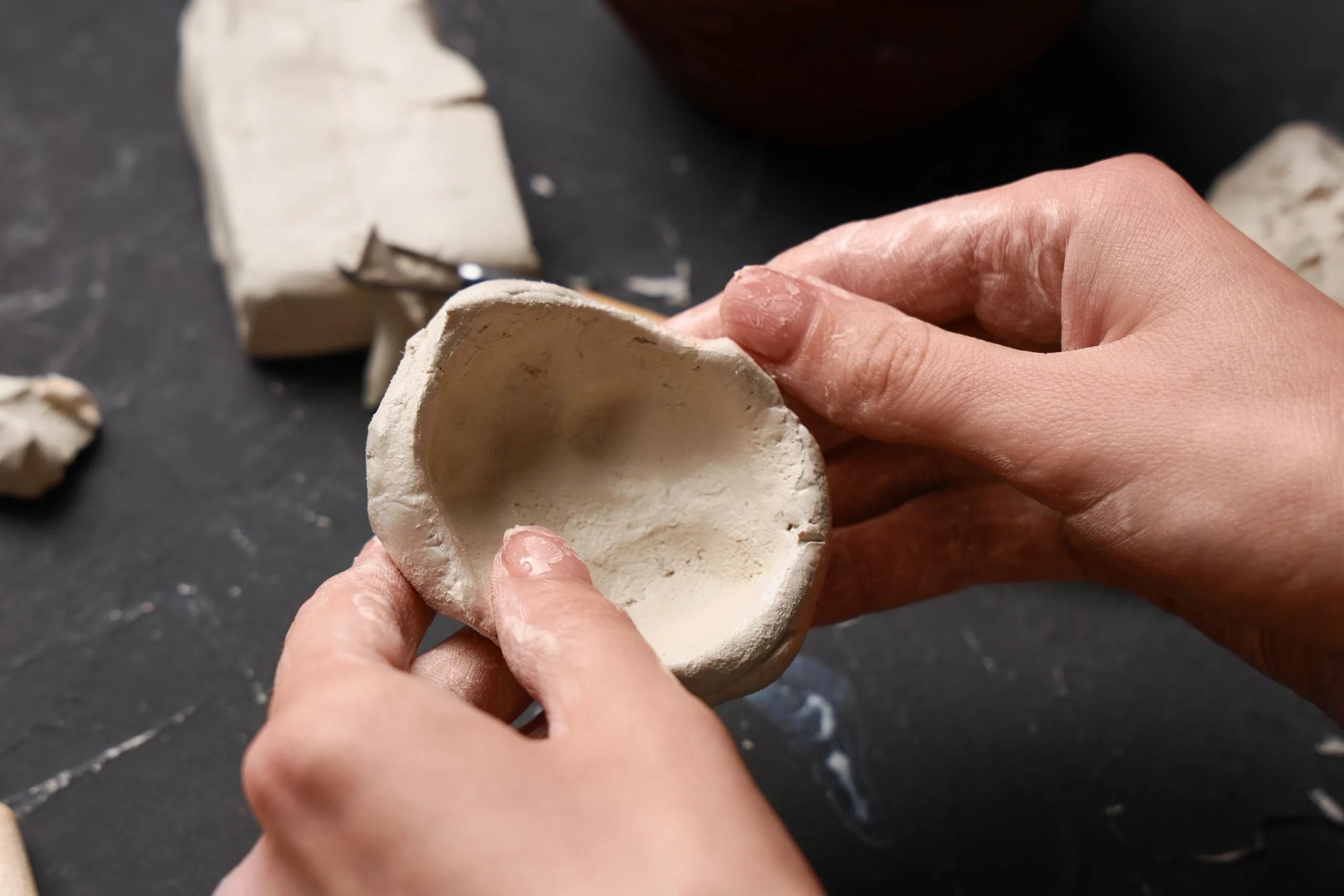 Hands sculpting clay