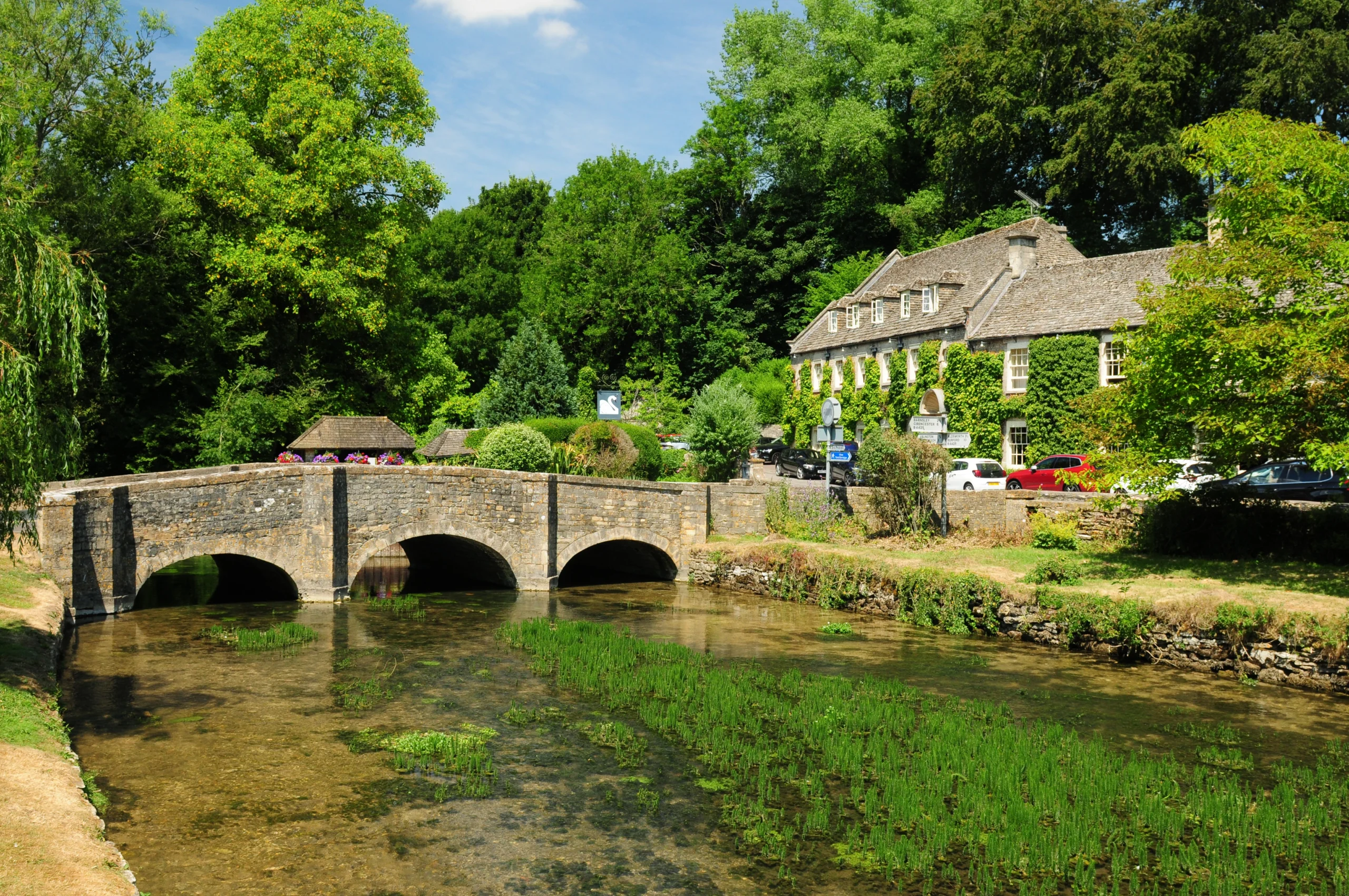 Idyllic Coln River In Bibury Cotswolds on a sunny day during The Cotswolds & Windsor Castle guided experience