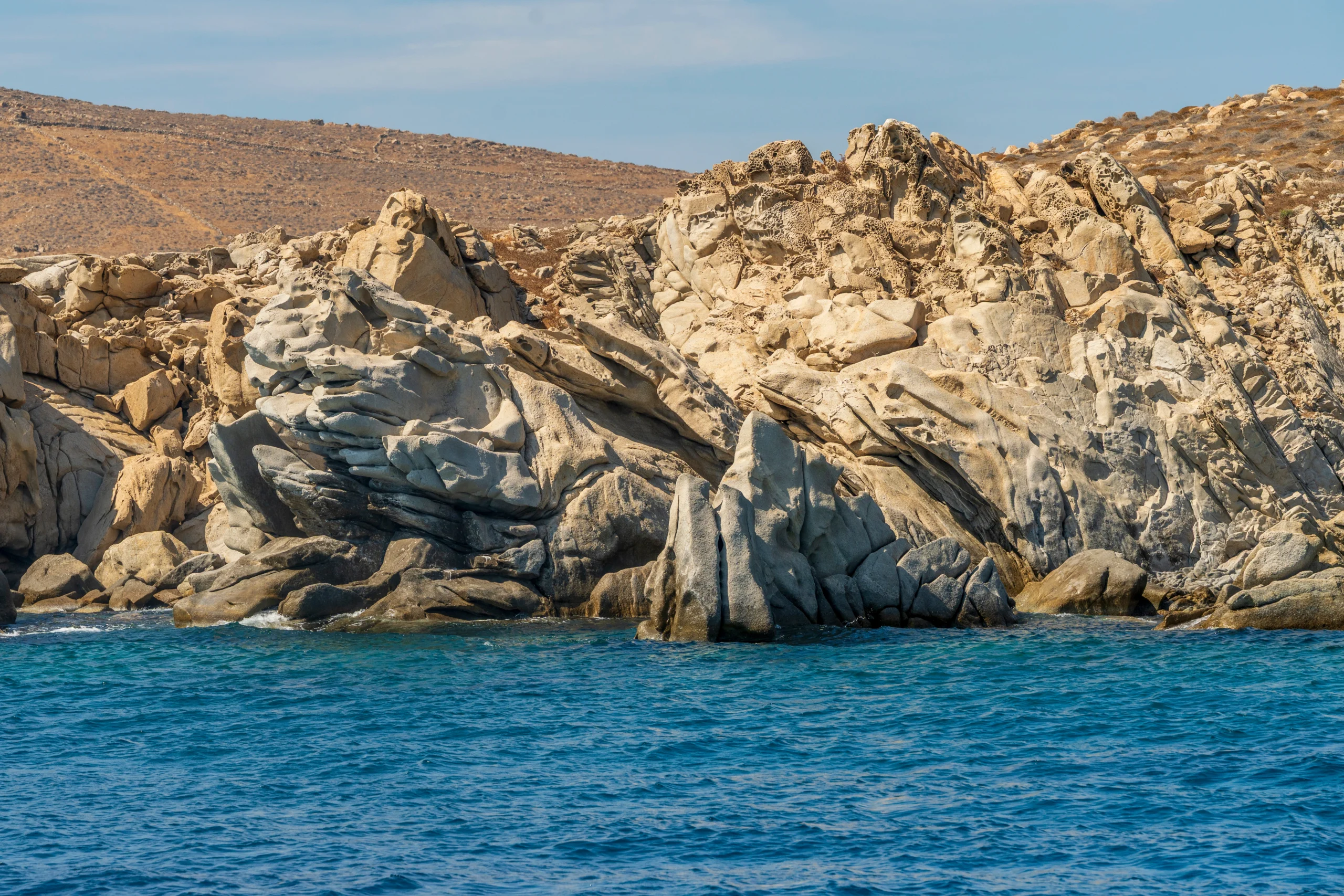 Rocky coastline and eroded cliffs on Delos island