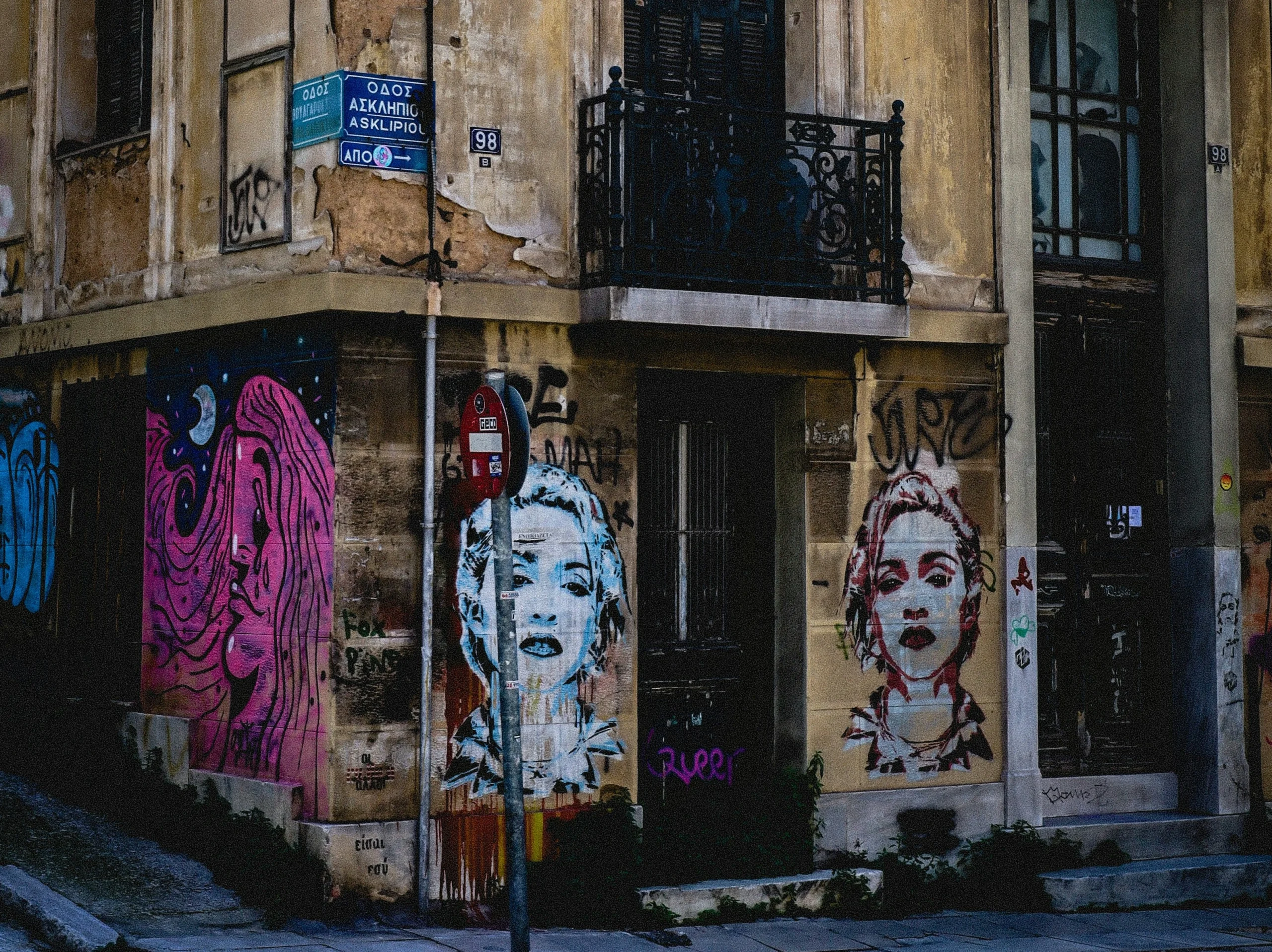 Street art mural of a woman's face on the corner of the street in Athens