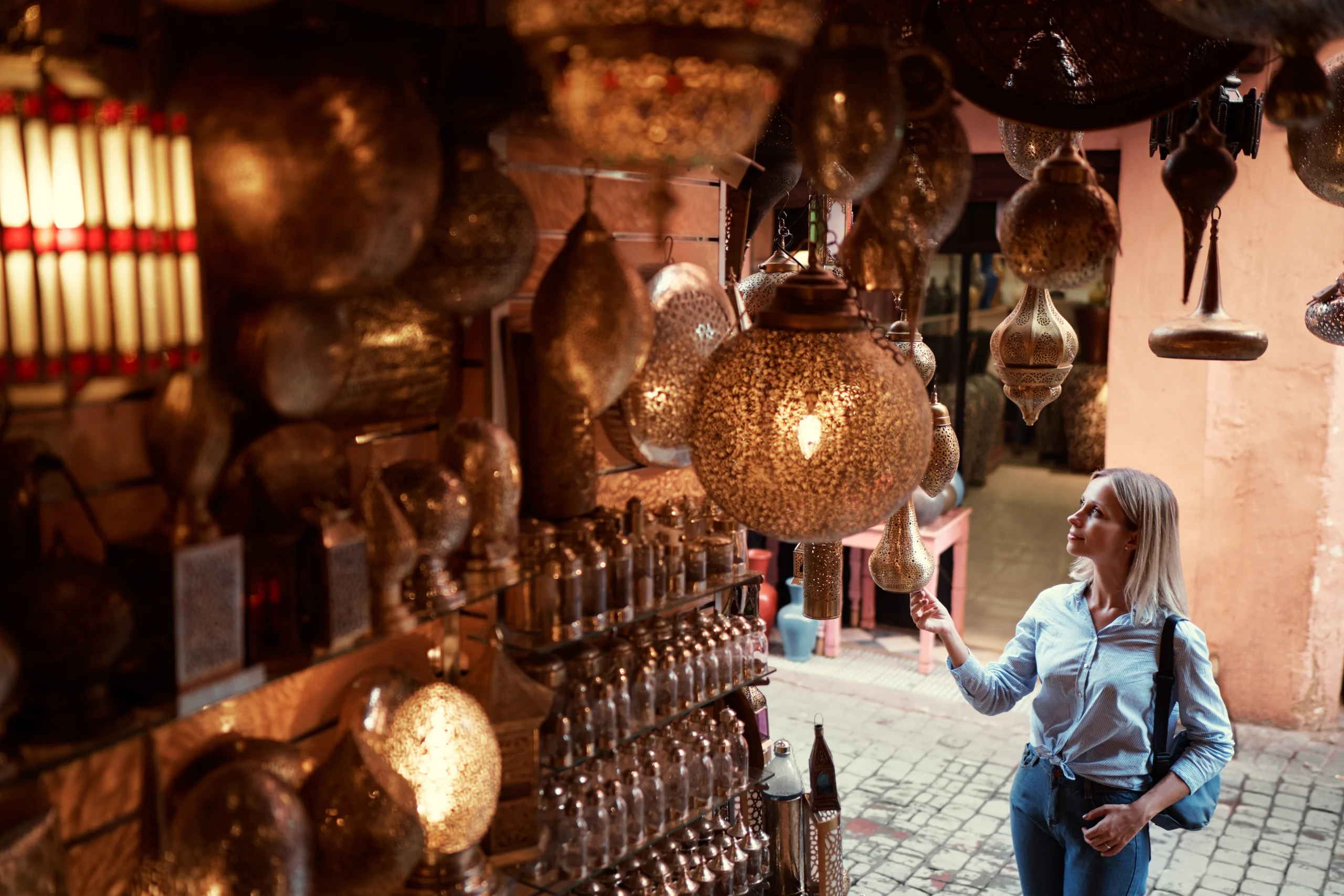 Traveler choosing Moroccan souvenirs during Artisan Workshops With a Local Designer tour