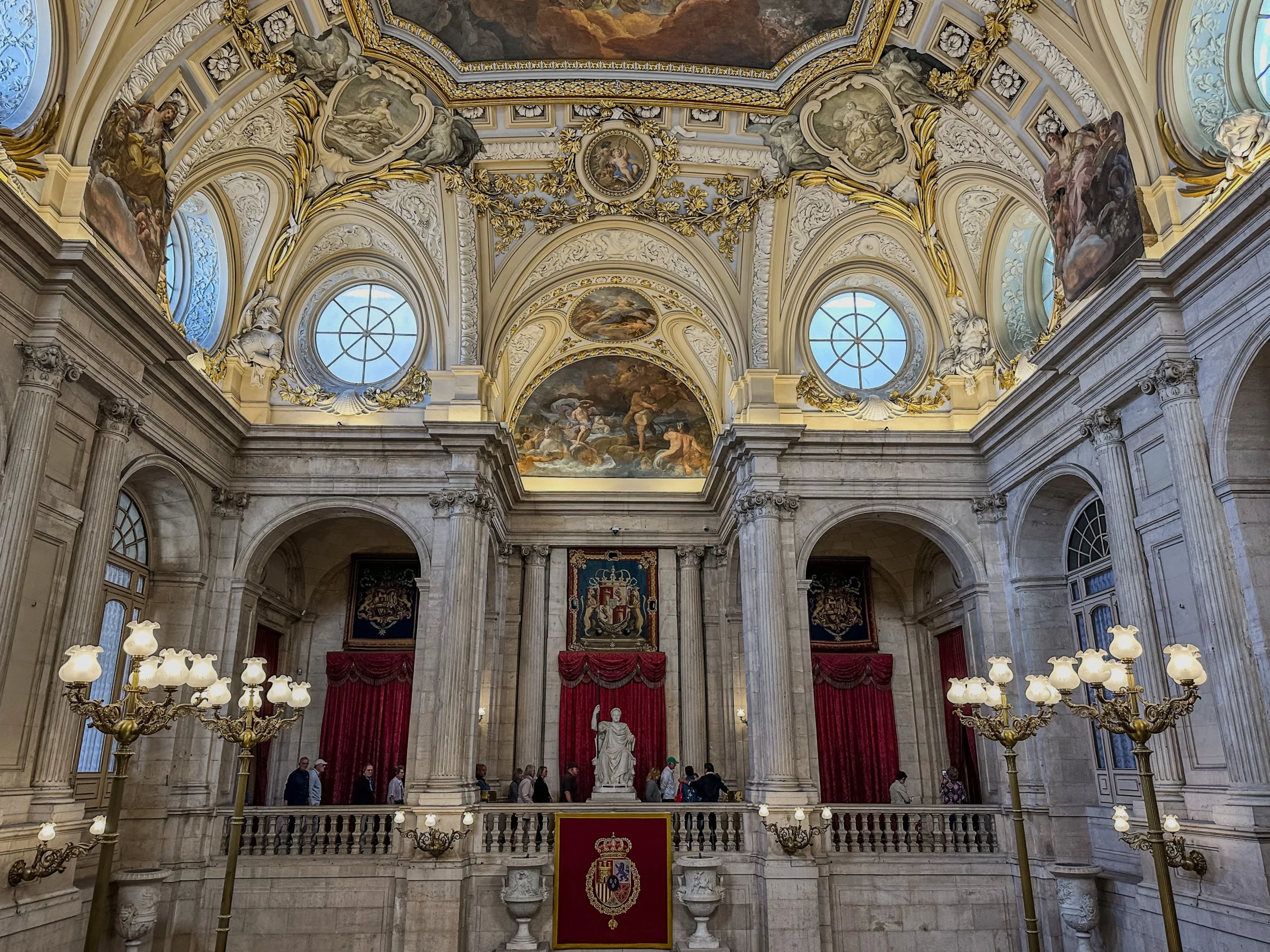Travelers inside the Royal Palace of Madrid