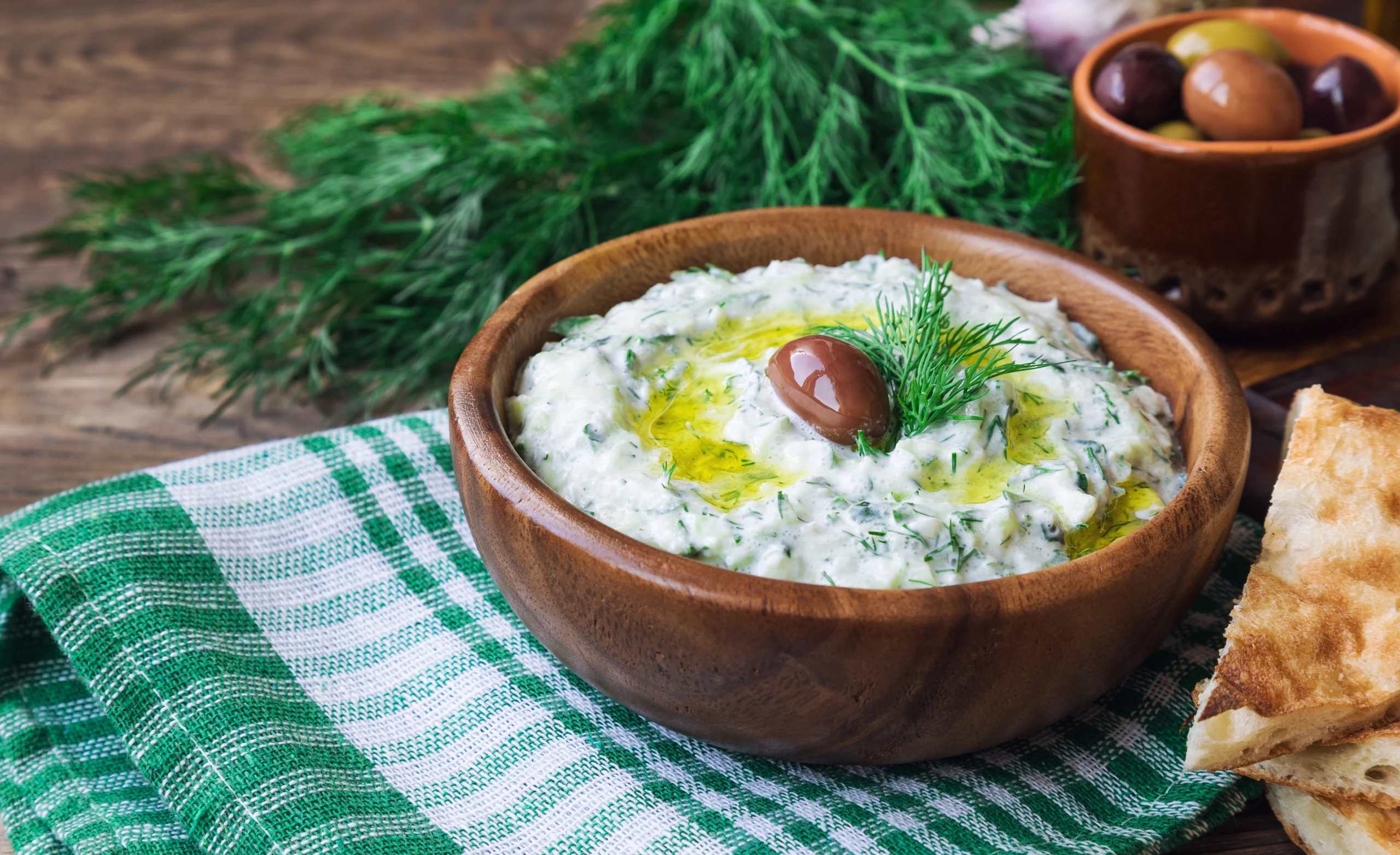 Tzatziki sauce in wooden bowl