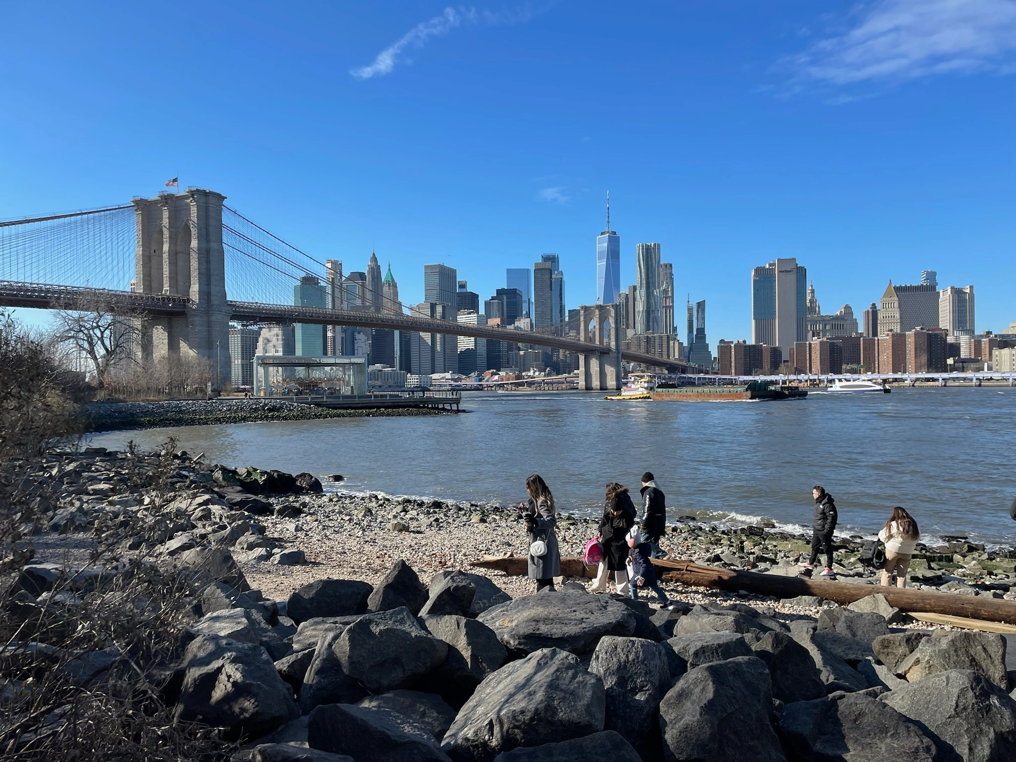 View of Brooklyn Bridge by the sea during guided DUMBO foodie experience in New York City