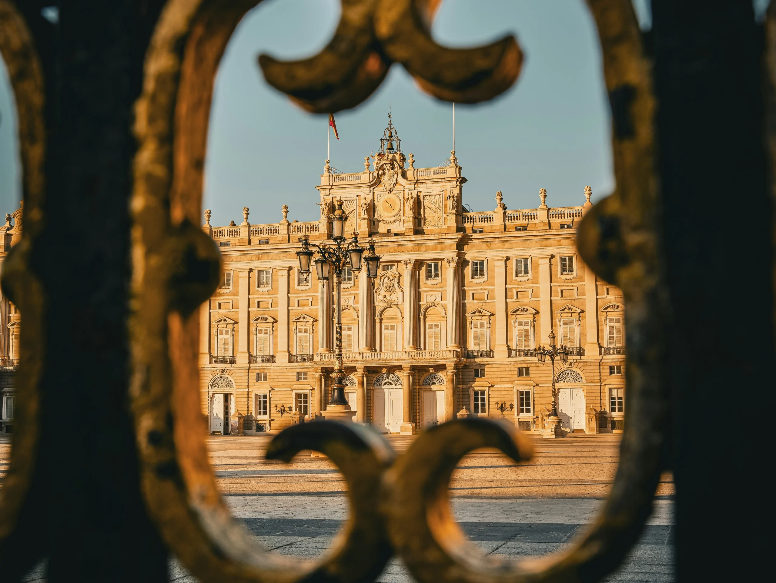 View of the Royal Palace of Madrid through an ornate gate during Prado Museum & Royal Palace With a Historian experience