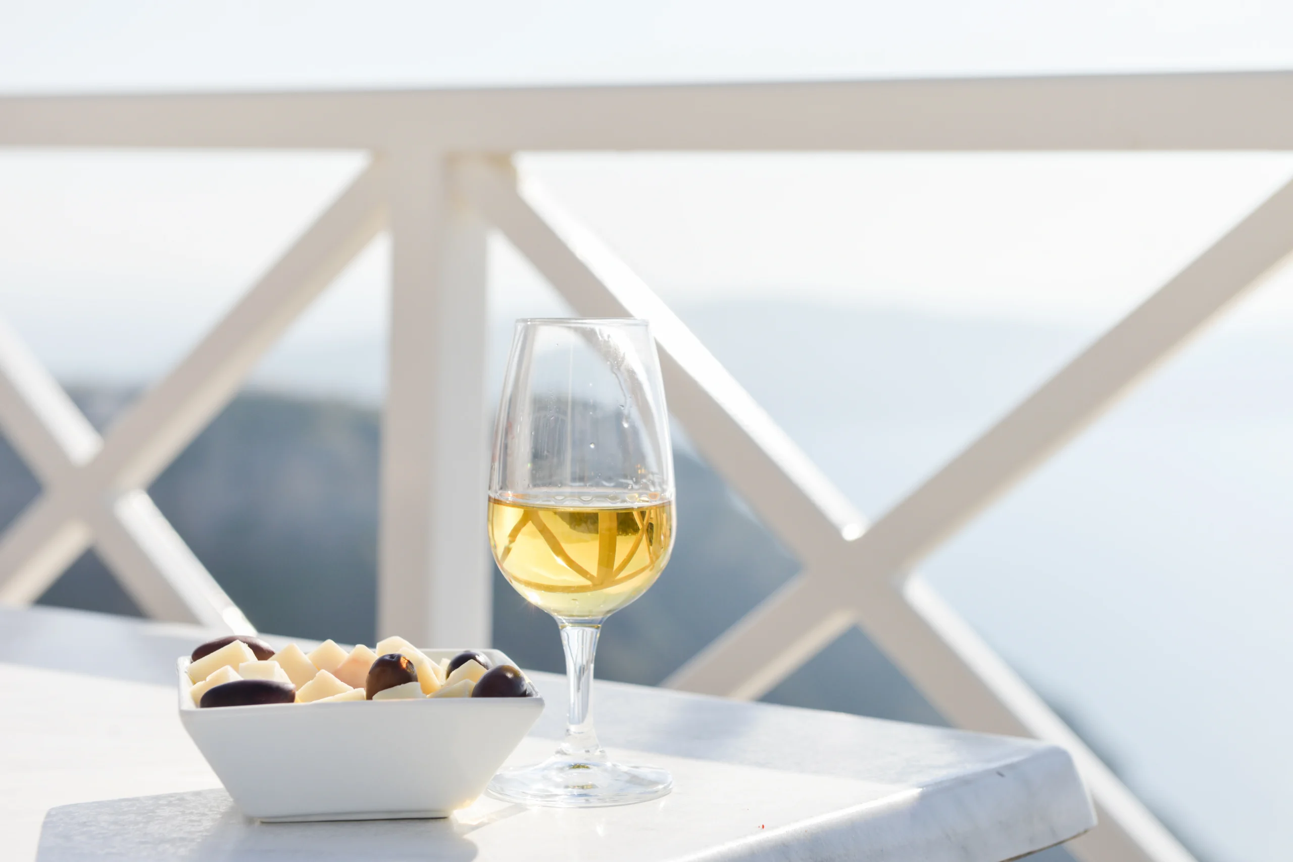 Wine and snacks on table during premium Wine Tasting Experience in Santorini