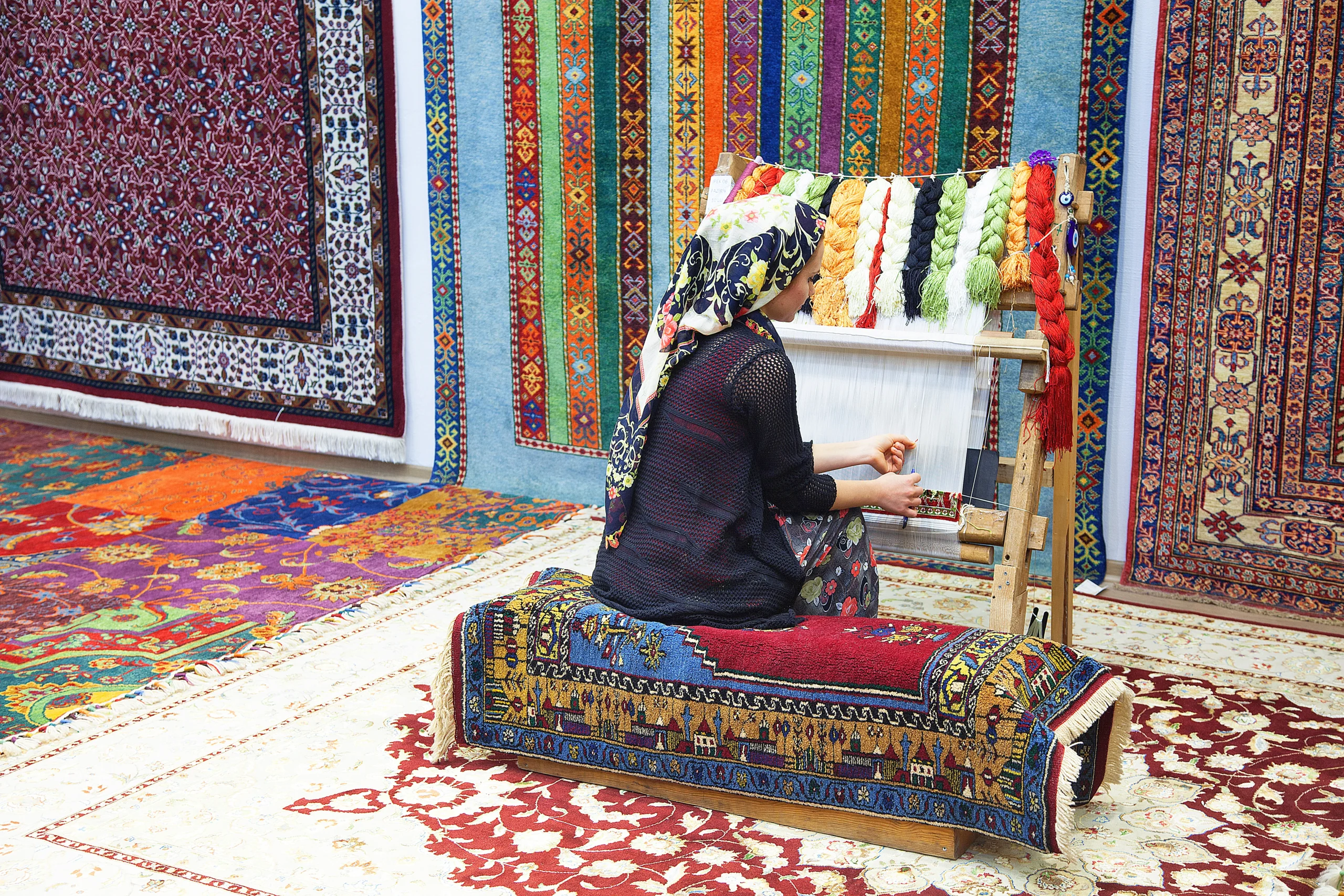 Woman hands weaving carpet on the loom during Artisan Workshops With a Local Designer tour