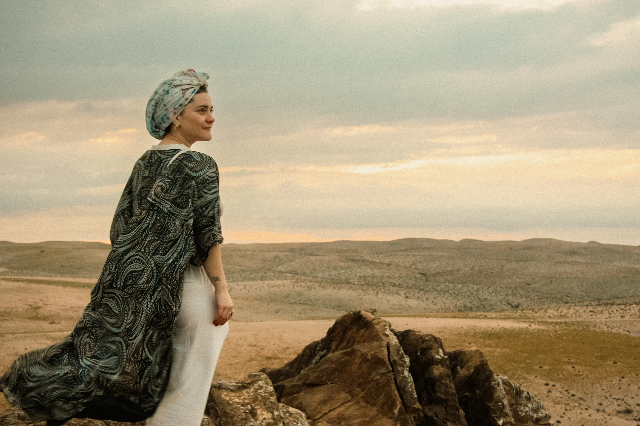 Woman standing in the Agafay Desert near Marrakech during Vintage Sidecar Escape to a Lakeside Farmhouse experience