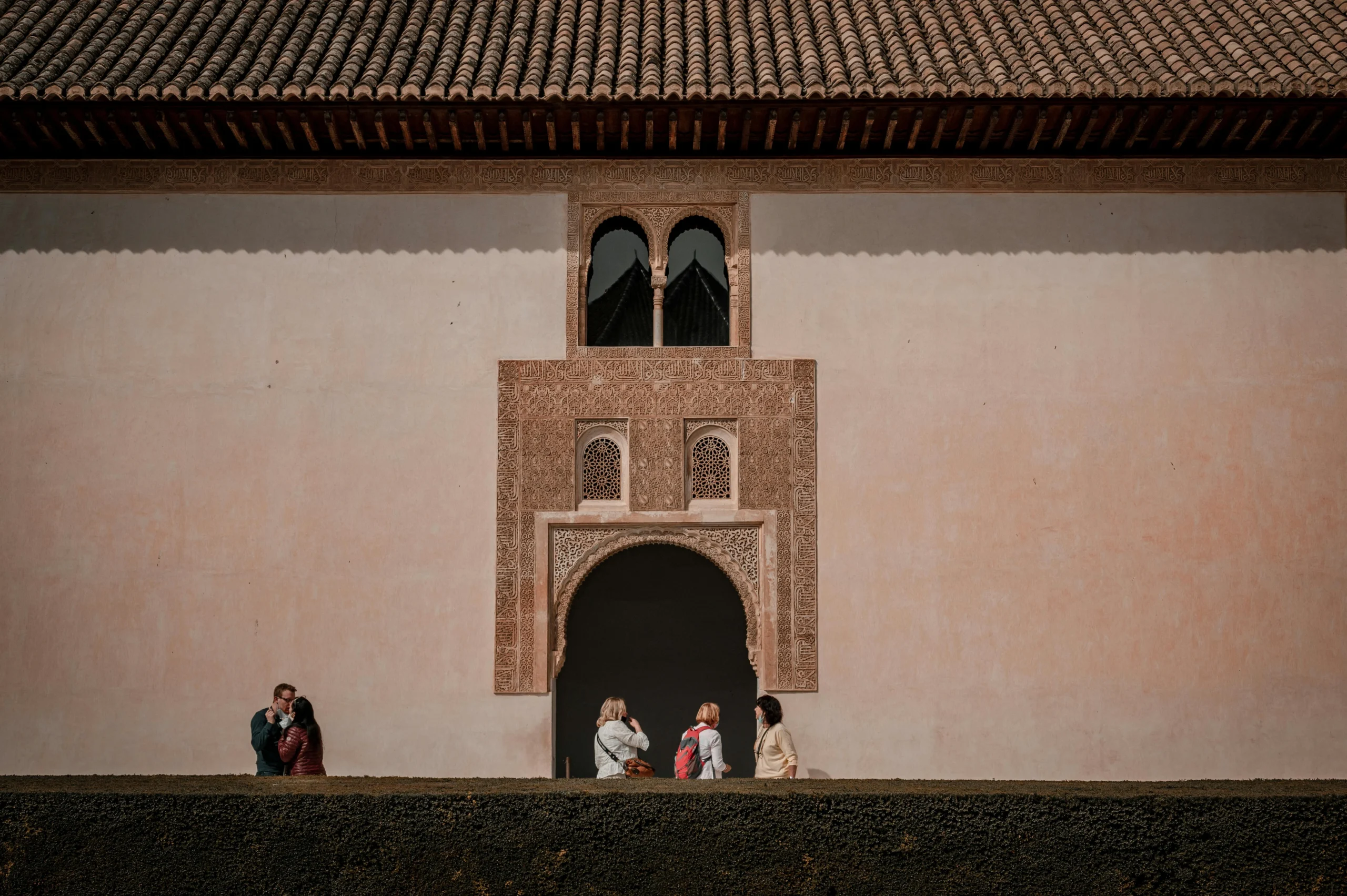 Arched doorway and people walking by in Alhambra